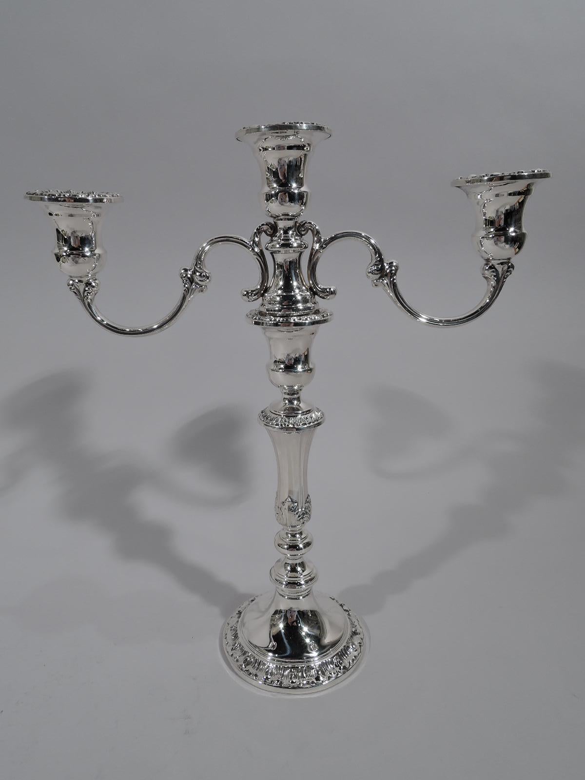 Pair of Classical 3-light sterling silver candelabra. Made by Gorham in Providence. Each: Tapering and knopped shaft with acanthus leaves on domed foot. Central light on spread base mounted with two scrolled arms, each terminating in single socket.