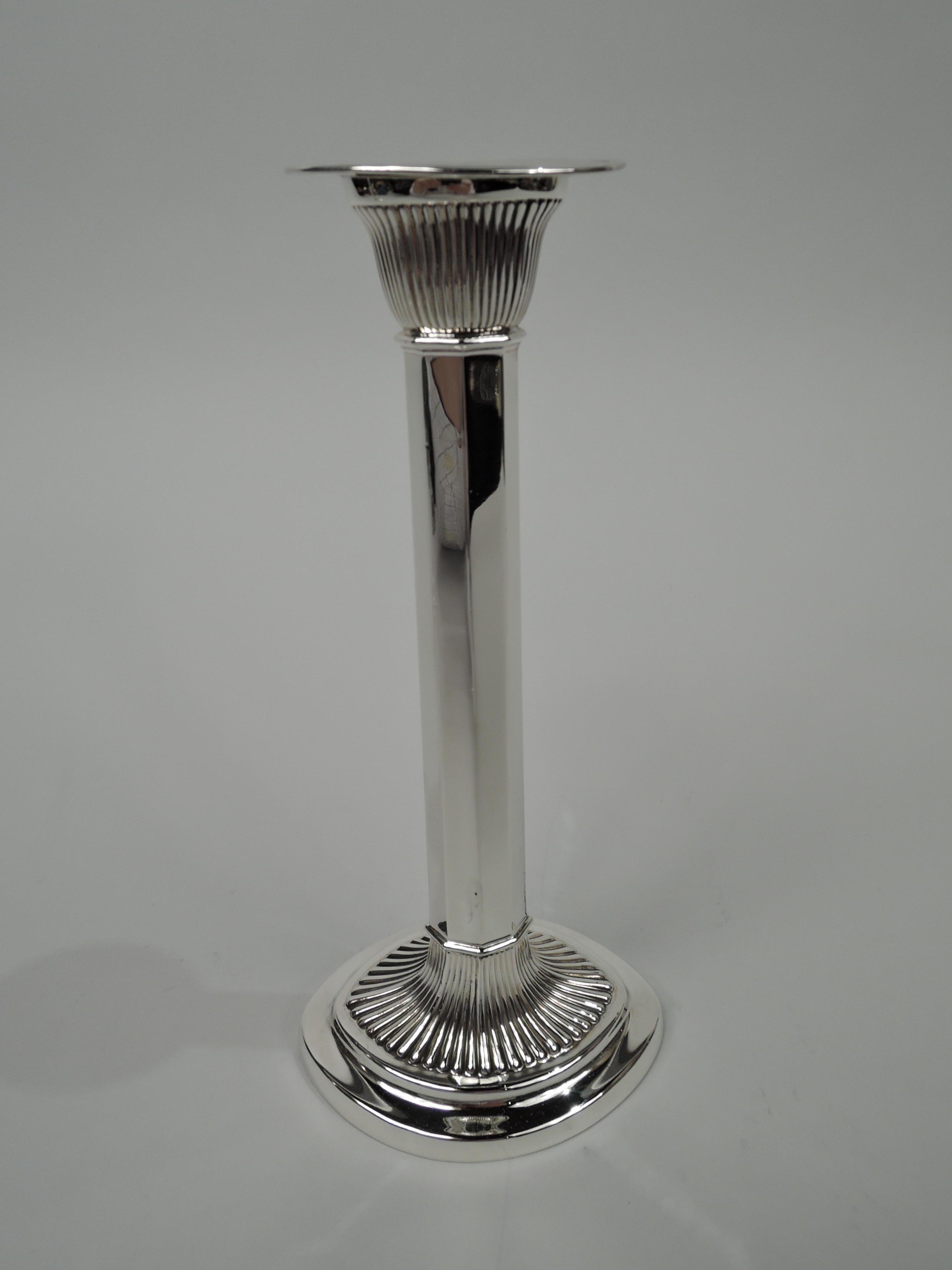 Pair of Edwardian Modern sterling silver candlesticks. Made by Gorham in Providence in 1905. Ovoid with faceted upward tapering haft on raised foot. Socket tapering with detachable bobeche. Dramatic ribbing on socket and foot. Fully marked including