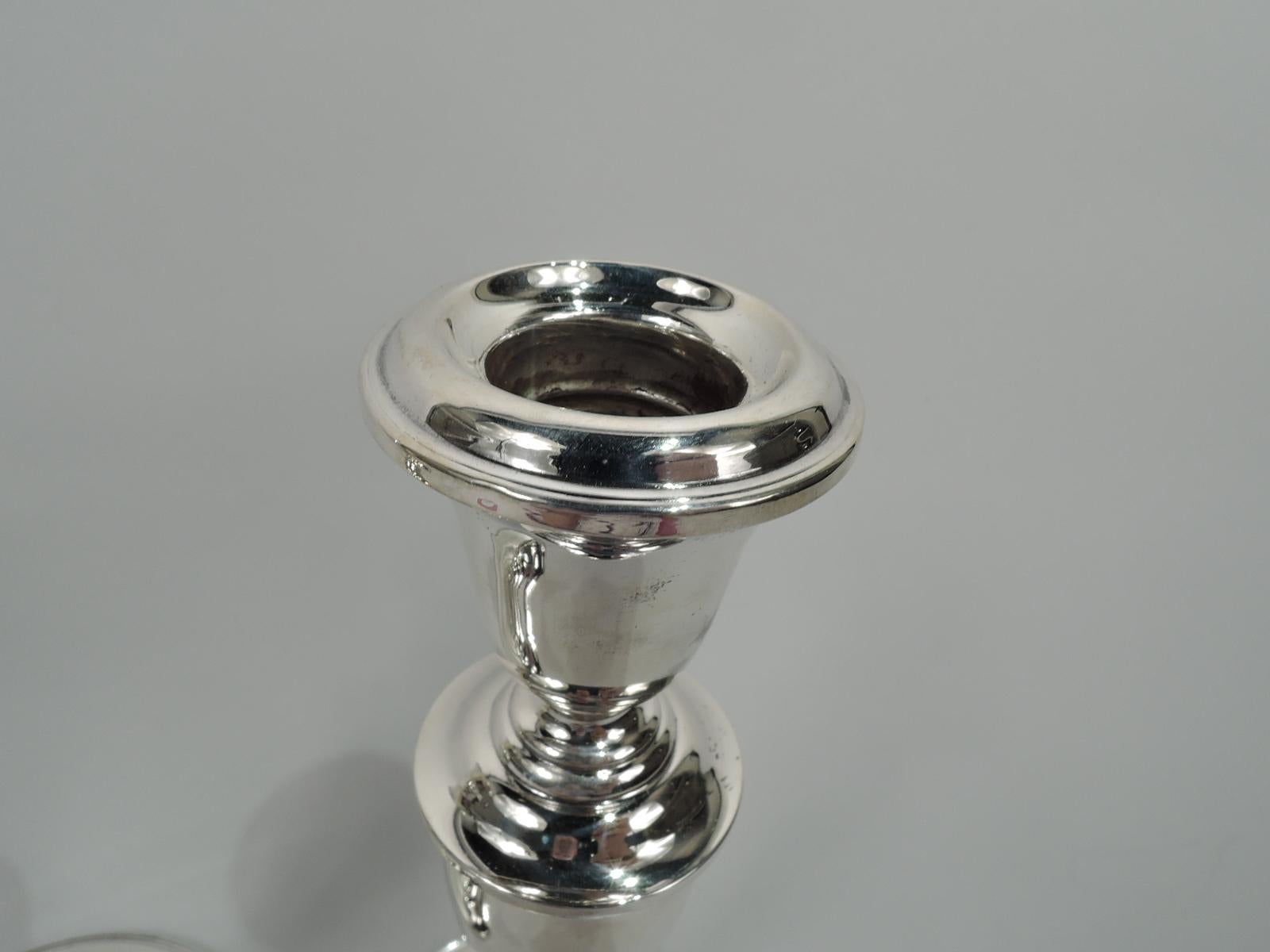 Pair of modern Georgian sterling silver candlesticks. Made by Gorham in Providence. Each: Urn socket on baluster shaft on domed foot. Unfussy traditional form. The perfect housewarming gift. Fully marked including maker’s stamp and no. 815/1.