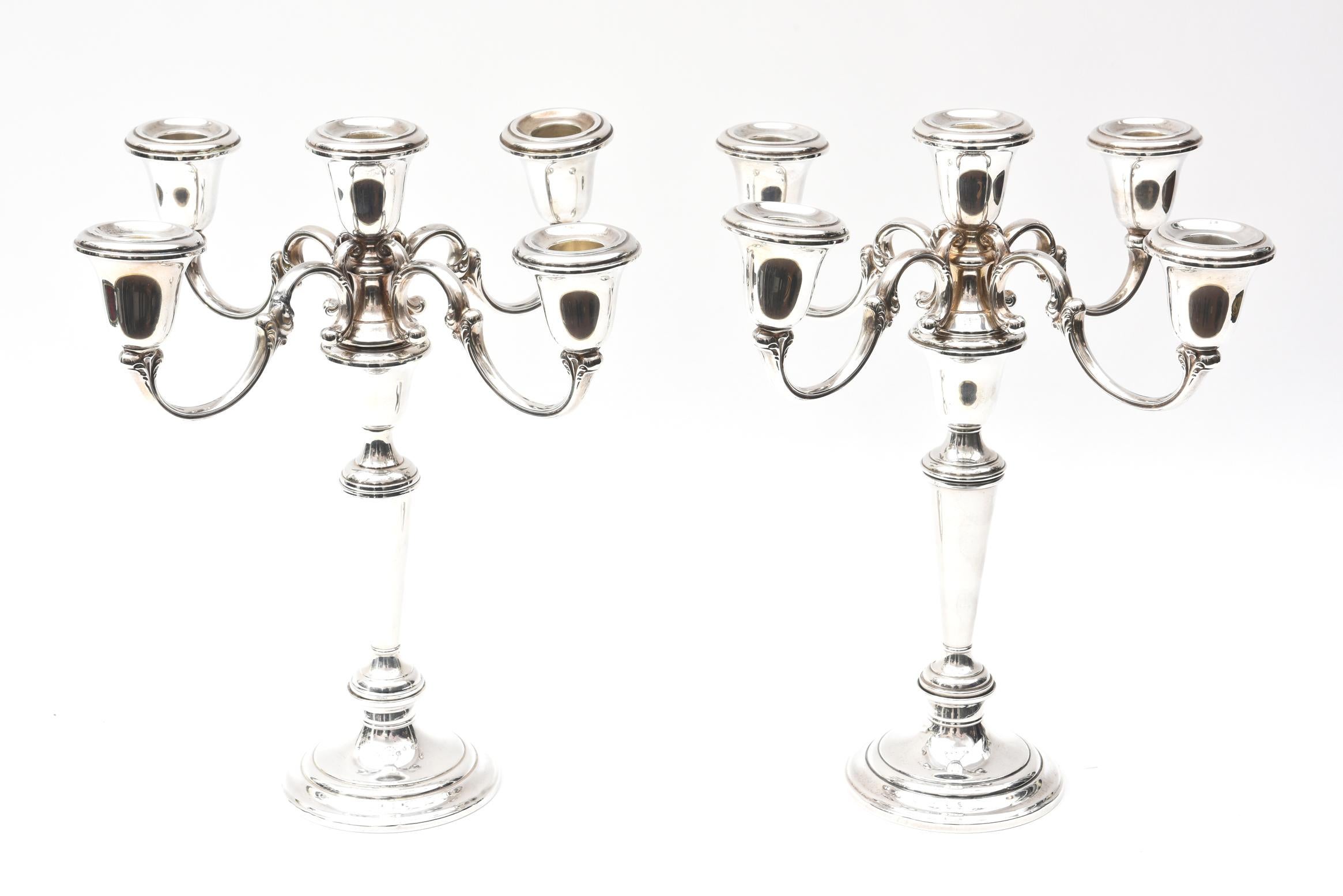 A classic and impressive 4-arm sterling candelabra from one of America's finest silversmith. This pair features crisp metal work and is a nice size with or without candles. Please note its convertible feature to change to single candlesticks. In