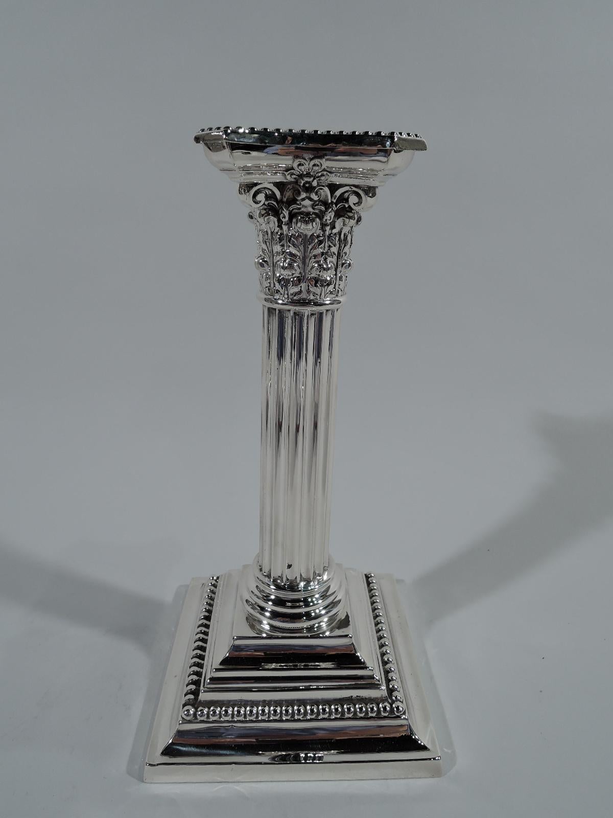Pair of sterling silver classical column candlesticks. Made by Gorham in Providence in 1906. Each fluted shaft on stepped square base. Composite capital with chamfered, concave, and detachable bobeche. Beading. Hallmark includes no. A3206 and date