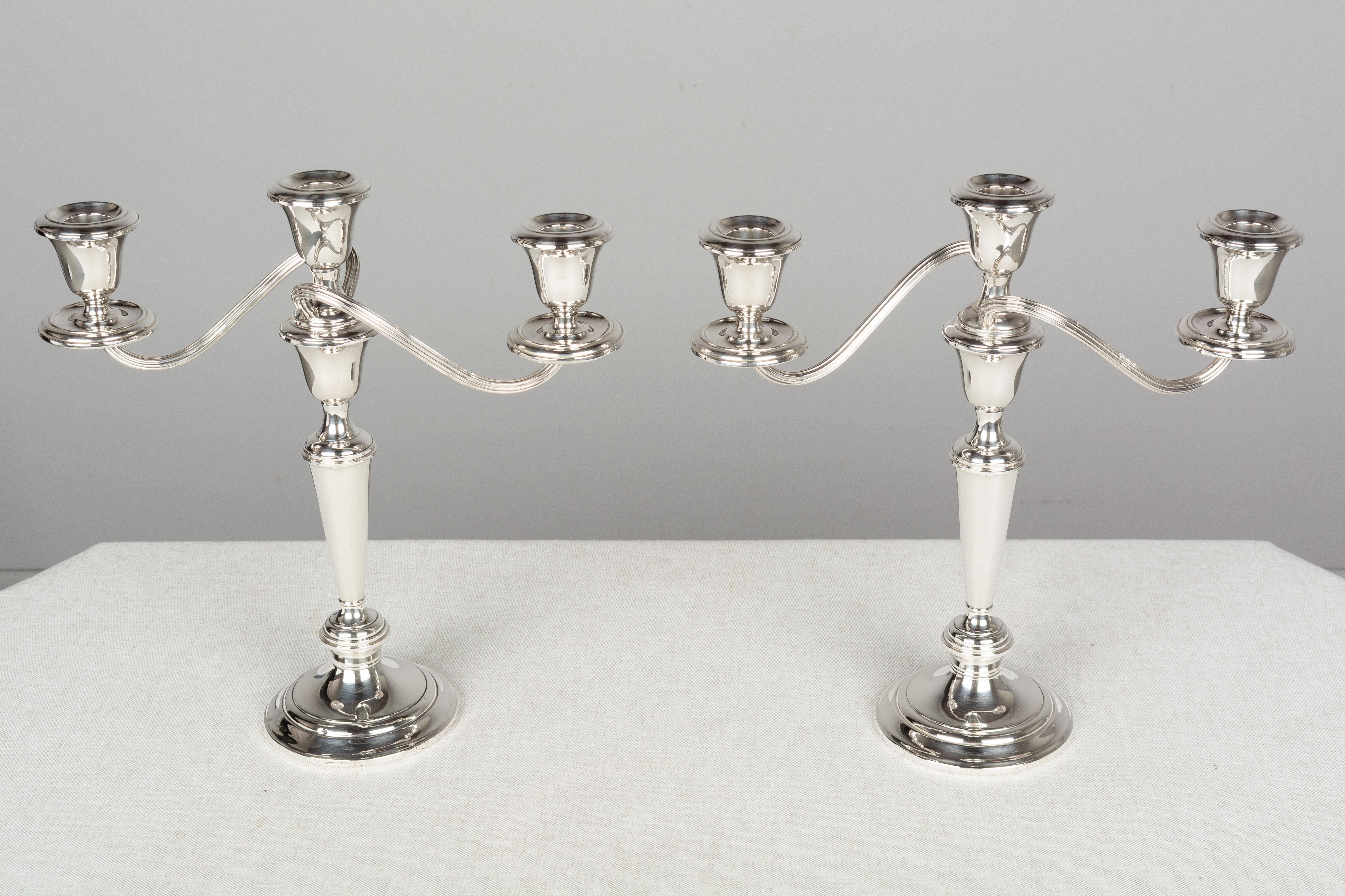 A pair of weighted 3-light sterling silver candelabra in the Puritan pattern by Gorham silversmiths. These were advertised as 