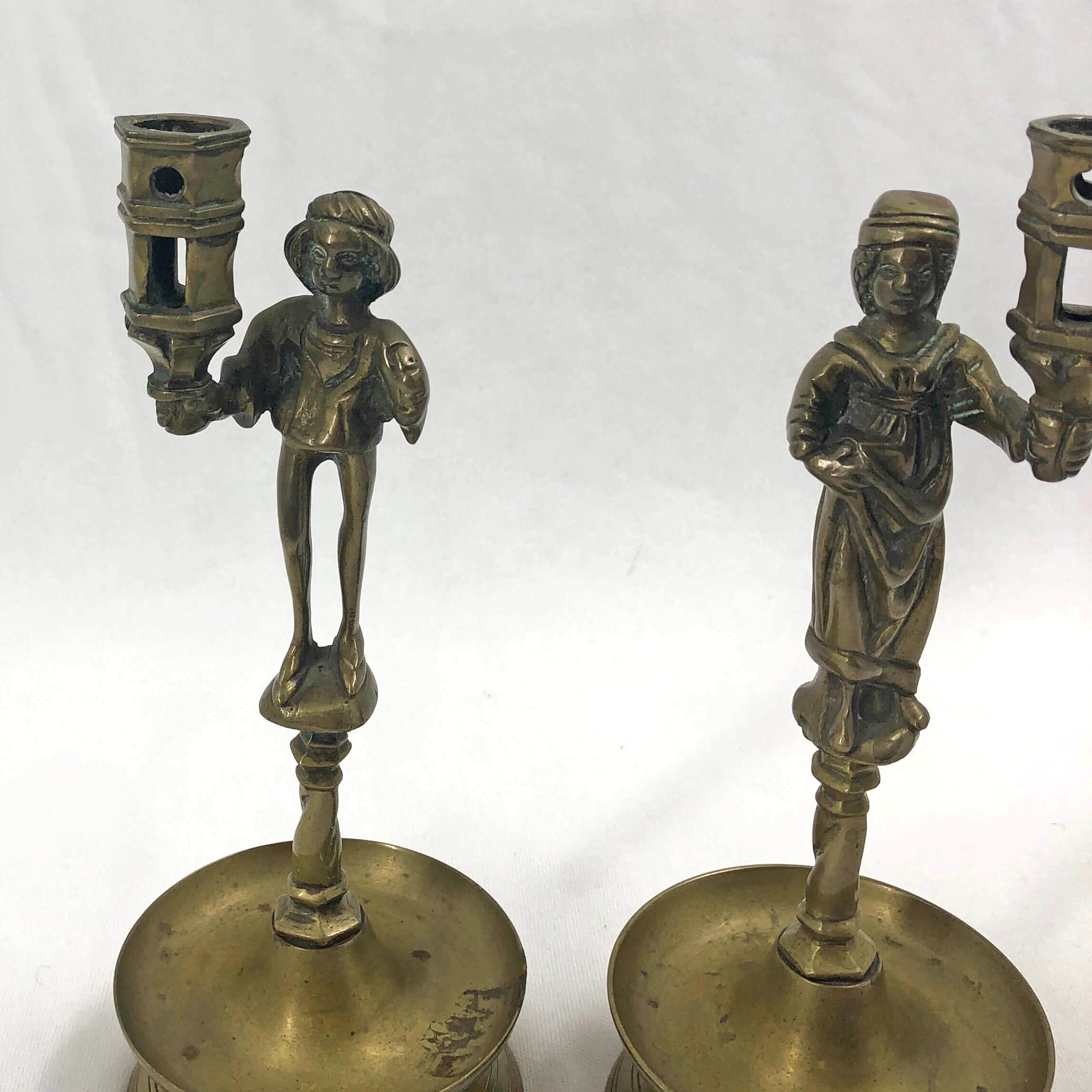 Pair of Gothic brass figural candlesticks.