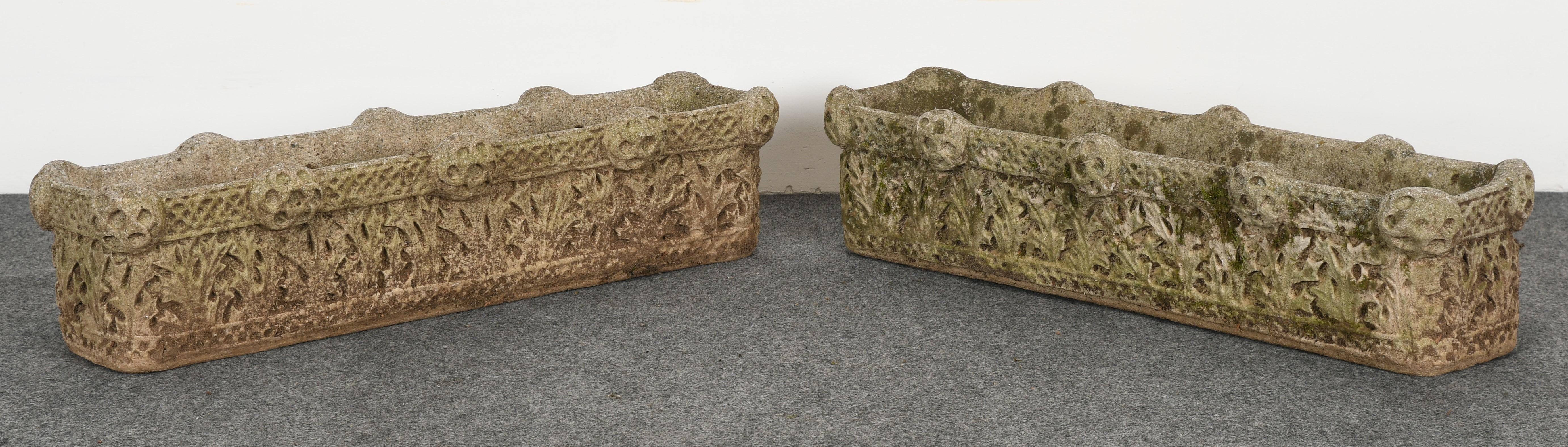 A stately pair of Gothic cast stone garden planters. These outdoor planters have a great patina with moss and lichen. These Arts & Crafts style planters were featured on a Pennsylvania estate. They are structurally sound and in good condition with