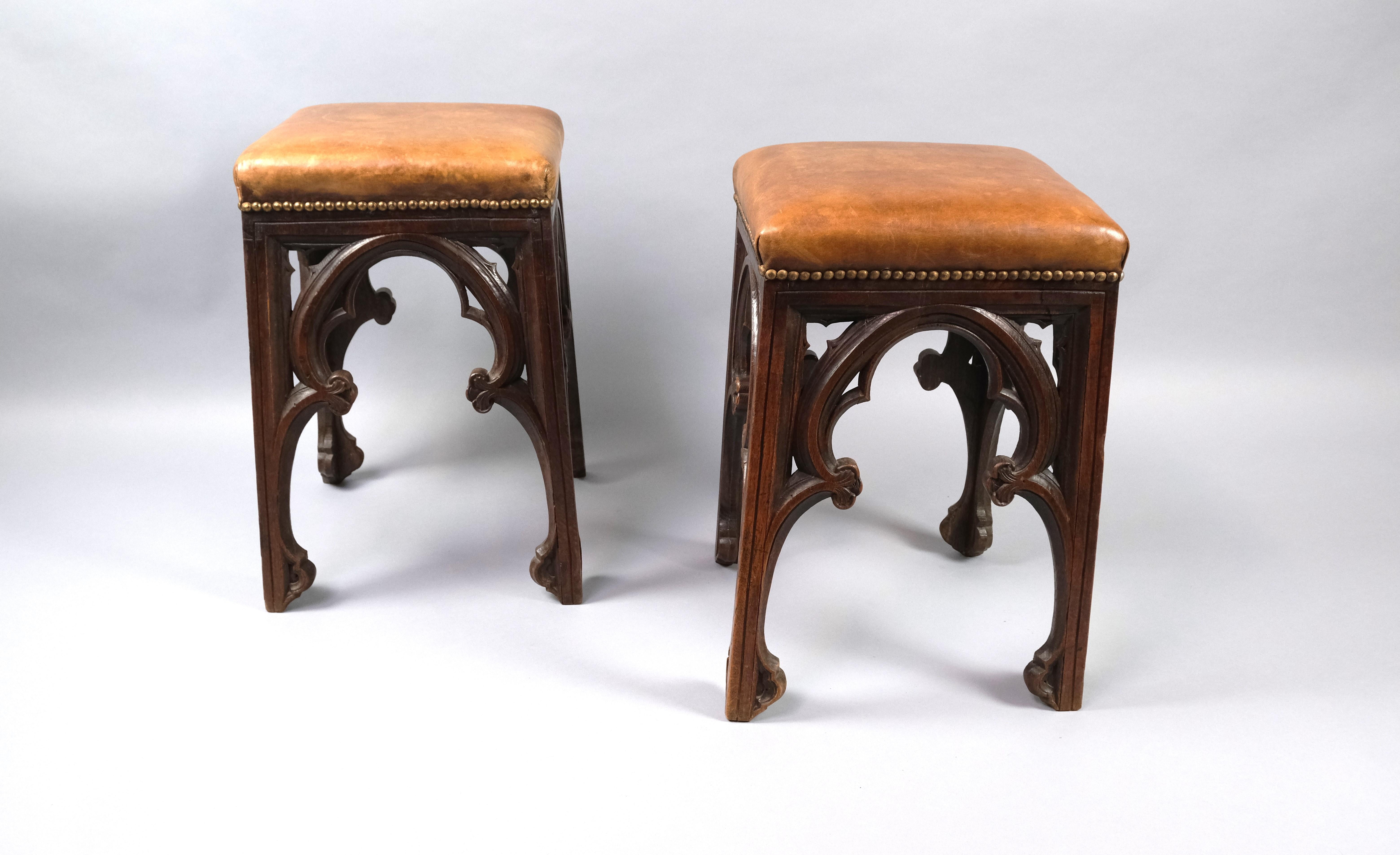 Hutton-Clarke Antiques is delighted to present this exceptional Pair of Late 19th-Century French Gothic Antique Oak Stools. These stools boast strikingly high proportions and are distinguished by their beautifully patinated leather seats.

These