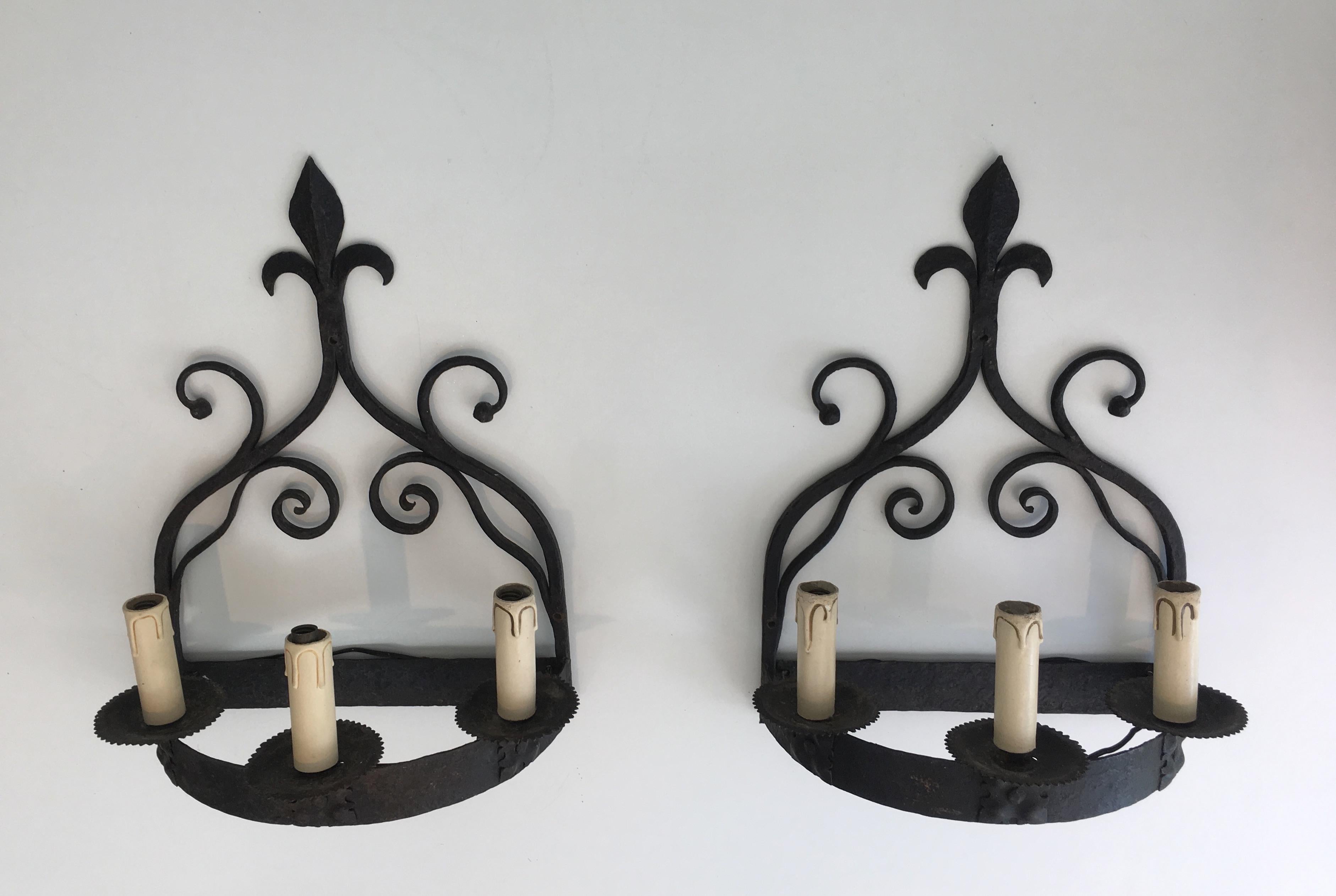This pair of Gothic style wall sconces is made of wrought iron. These wall lights have 3-light. These are very decorative and the quality is really good. The sconces can be used with bulbs or could be used with real candles as well (we can have the