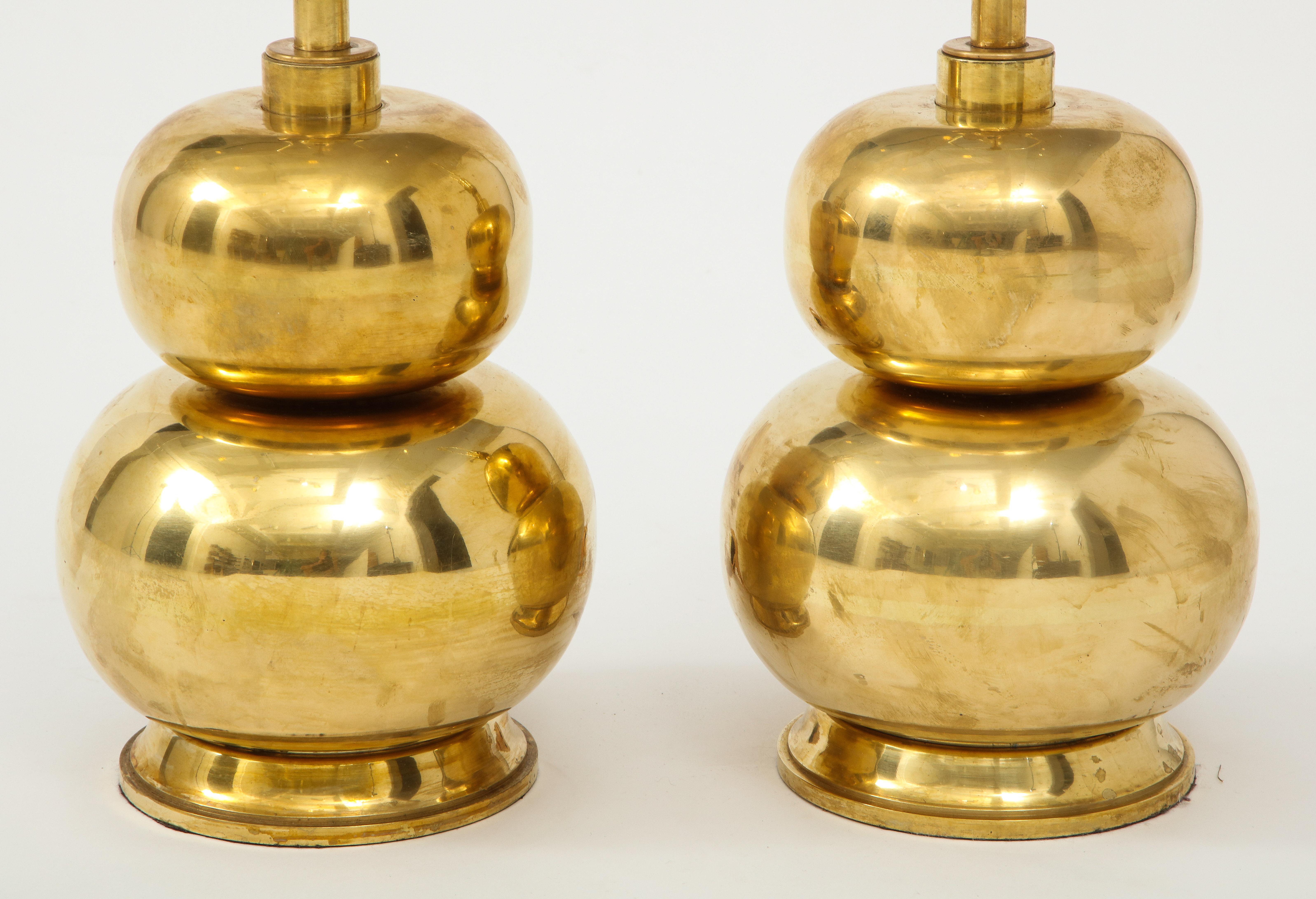 A pair of eye catching gourd shaped lamps in brass on a brass base with a wonderful warm patina. A great way to add a bit of shine to a room!