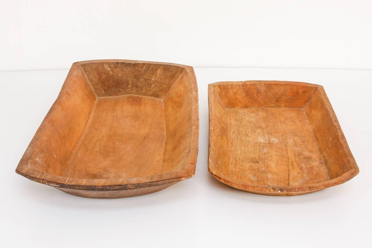 Interesting pair of hand-carved graduated dough bowls or troughs. The smaller bowl measures 26
