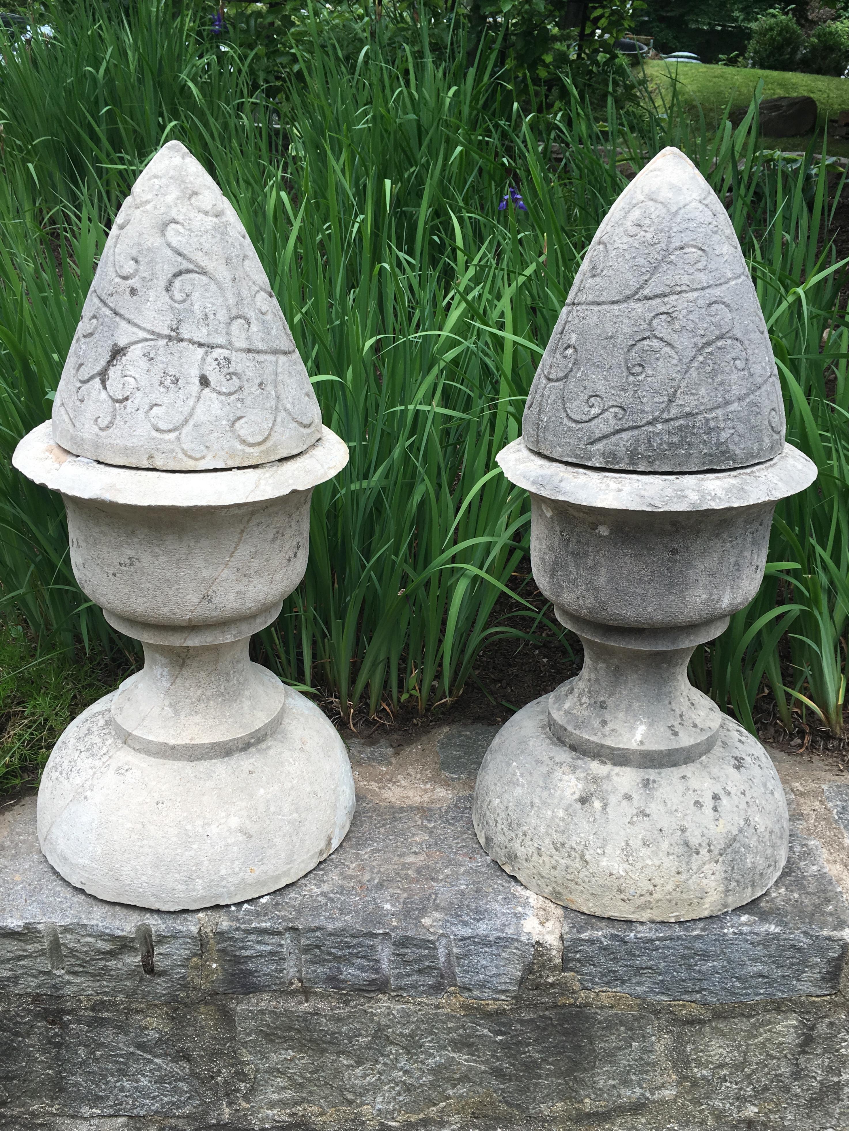 This pair of large finials (each in two parts) is hand-carved from French limestone and features a rare vine-design swirled incised decoration to the conical tops. Beautifully weathered to a pale grey, they will make a stunning statement perched
