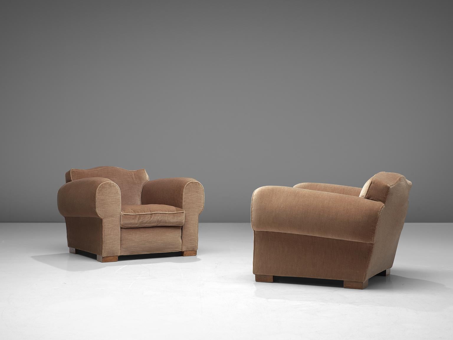 Maurice Rinck, pair of lounge chairs, velvet and oak, France, 1940s

Grand and comfortable set of two club chairs in taupe velvet upholstery. Truly extraordinary and luxurious chairs that feature a deep seat and large rounded, curved armrests. The