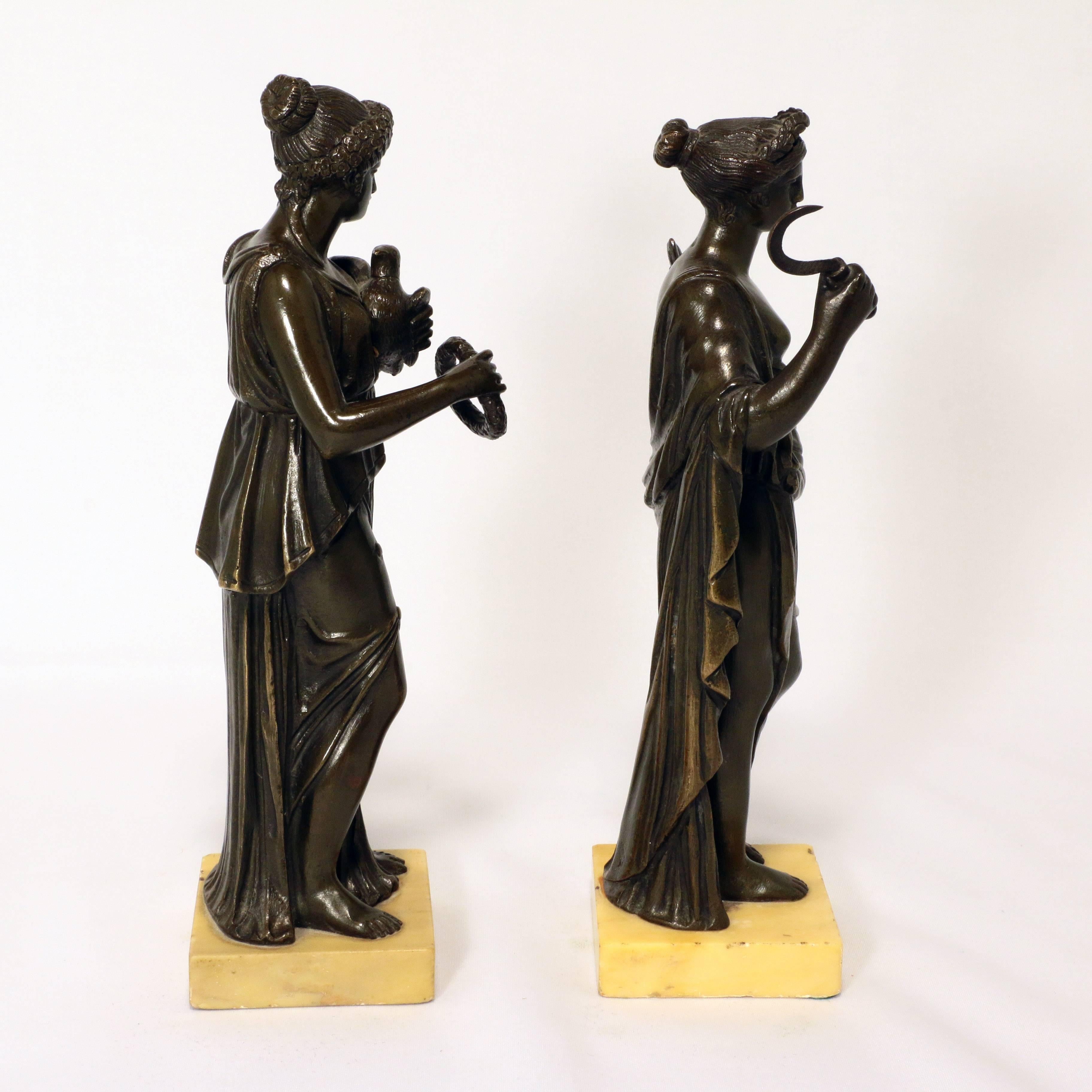 This striking pair, one of Ceres, emblematic of the harvest, the other with a dove and laurel wreath are well modelled as elegant figures in flowing gowns. Each is presented on a square pale ochre marble base.
