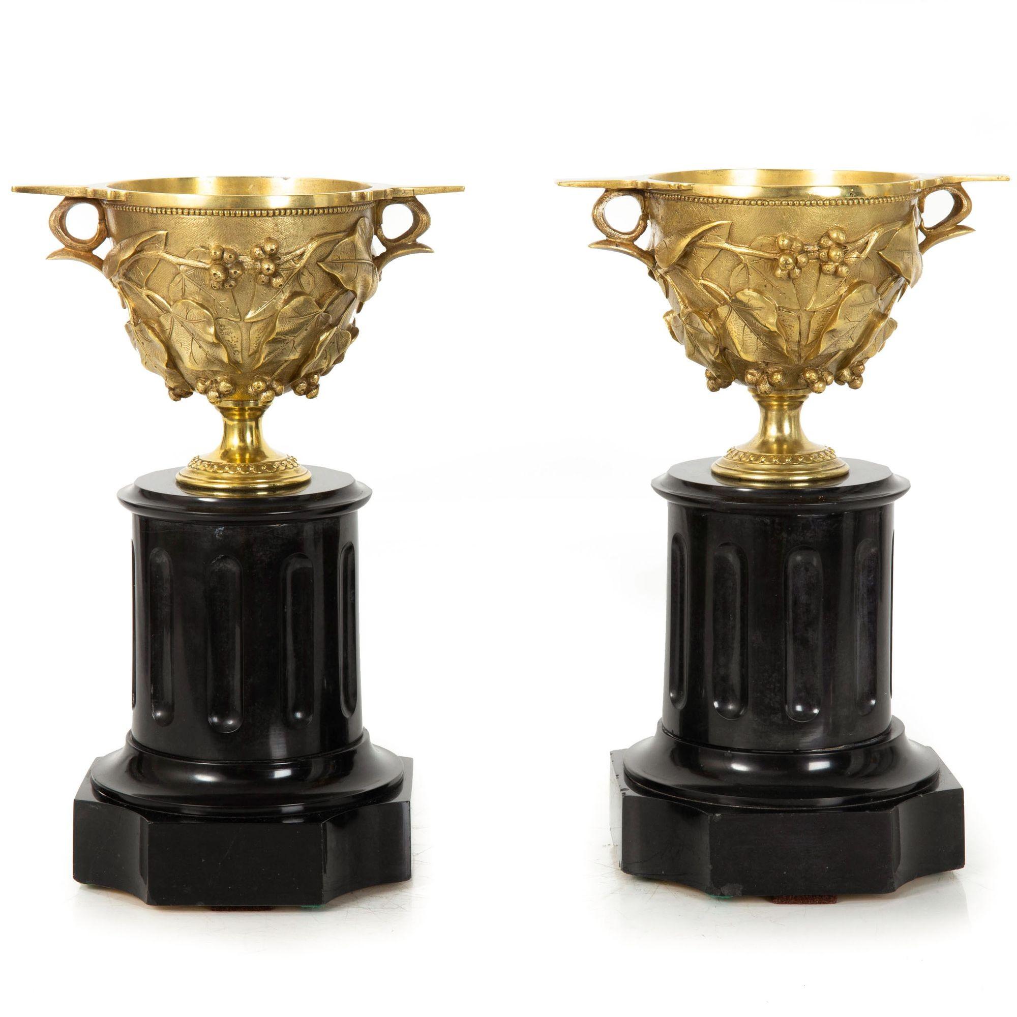 GRAND TOUR PAIR OF BRONZE IVY AND VINE BAS-RELIEF DECORATED TWO-HANDLED 'SCYPHUS' (OR 'SKYPHOS') CUPS ON BLACK MARBLE SOCLE AFTER ANTIQUITY
Cast by the foundry of Auguste Delafontaine, undersides of handles cold-stamped 