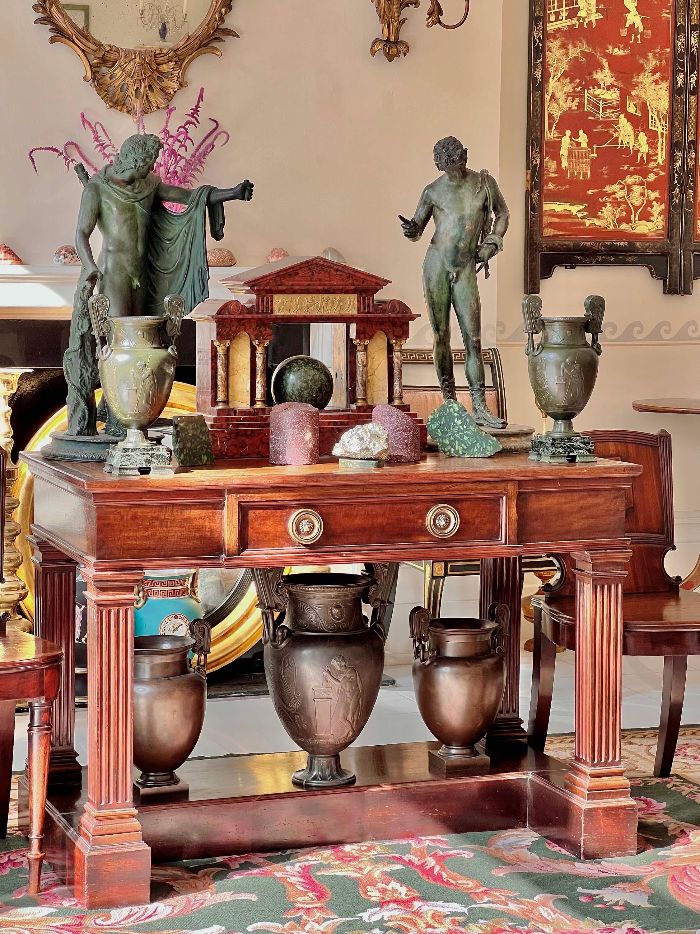 A decorative pair of Grand Tour bronze-patinated urns of ancient Greek 'volute krater' form, 
Italy, 19th century.

Why we like them
We love the decorative look of these urns, evoking the Grand Tour travels of the 19th century. Perfect for lamp