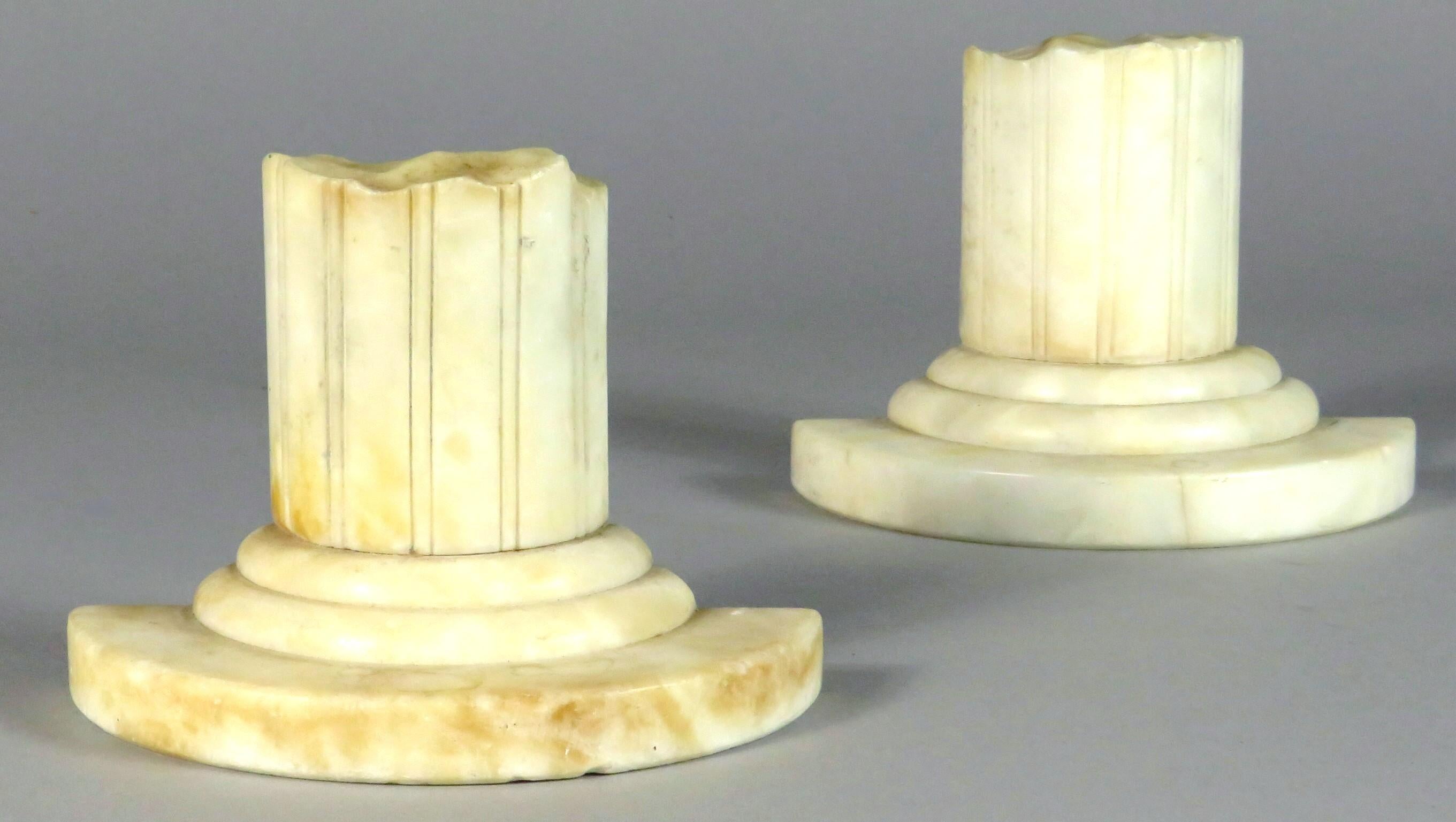 A very good pair of architectural inspired columnar bookends, both carved in the form of ancient ruins of reeded columns, raised on stepped bases. Dimensions noted are those shown facing front.