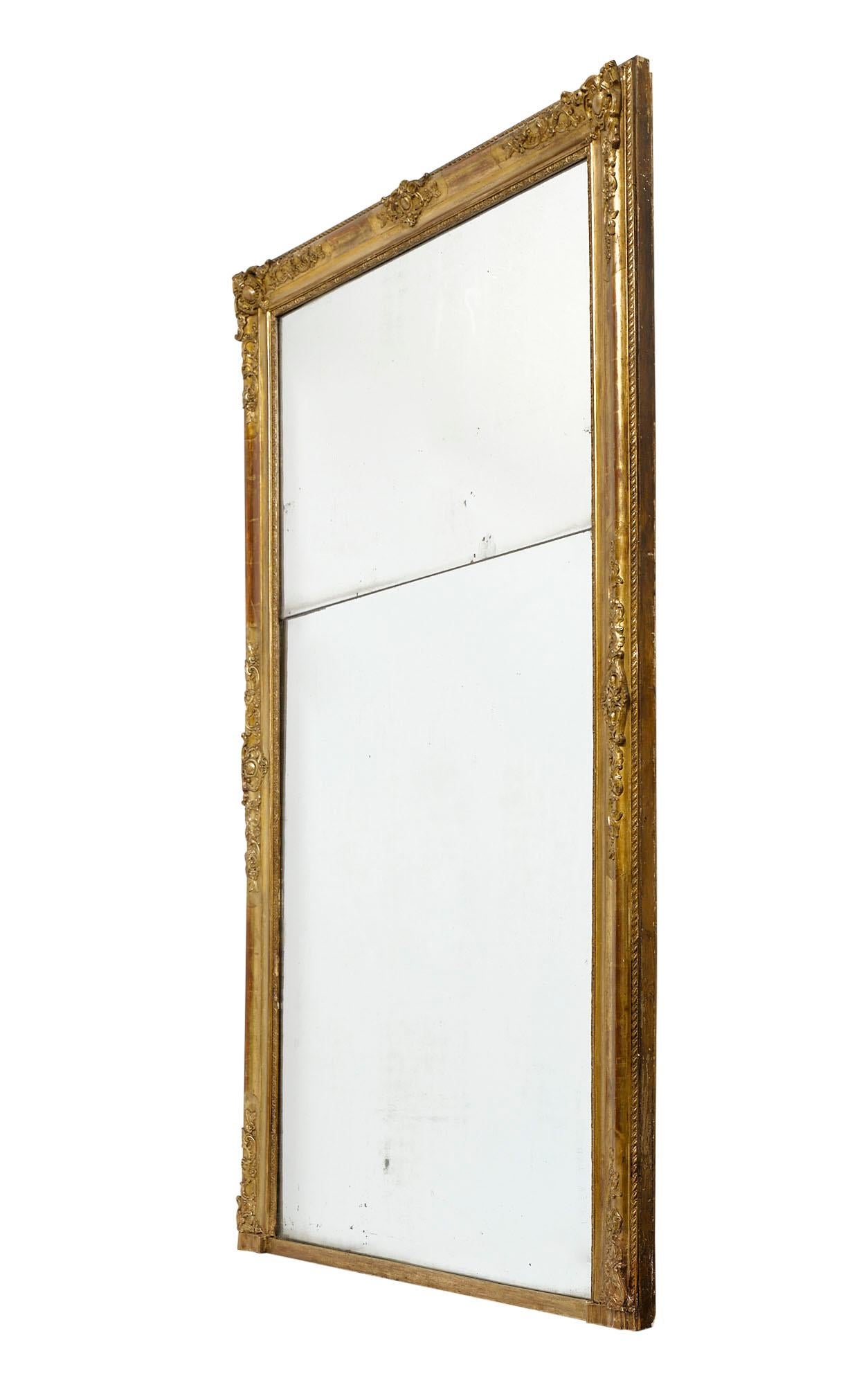 Pair of mirrors from France in the Louis XVI style. This 19th century pair has hand-carved wood frames with beautiful detail and original 23 carat gold leaf. The interior mercury mirror is also original and in two panels of mirror each. These