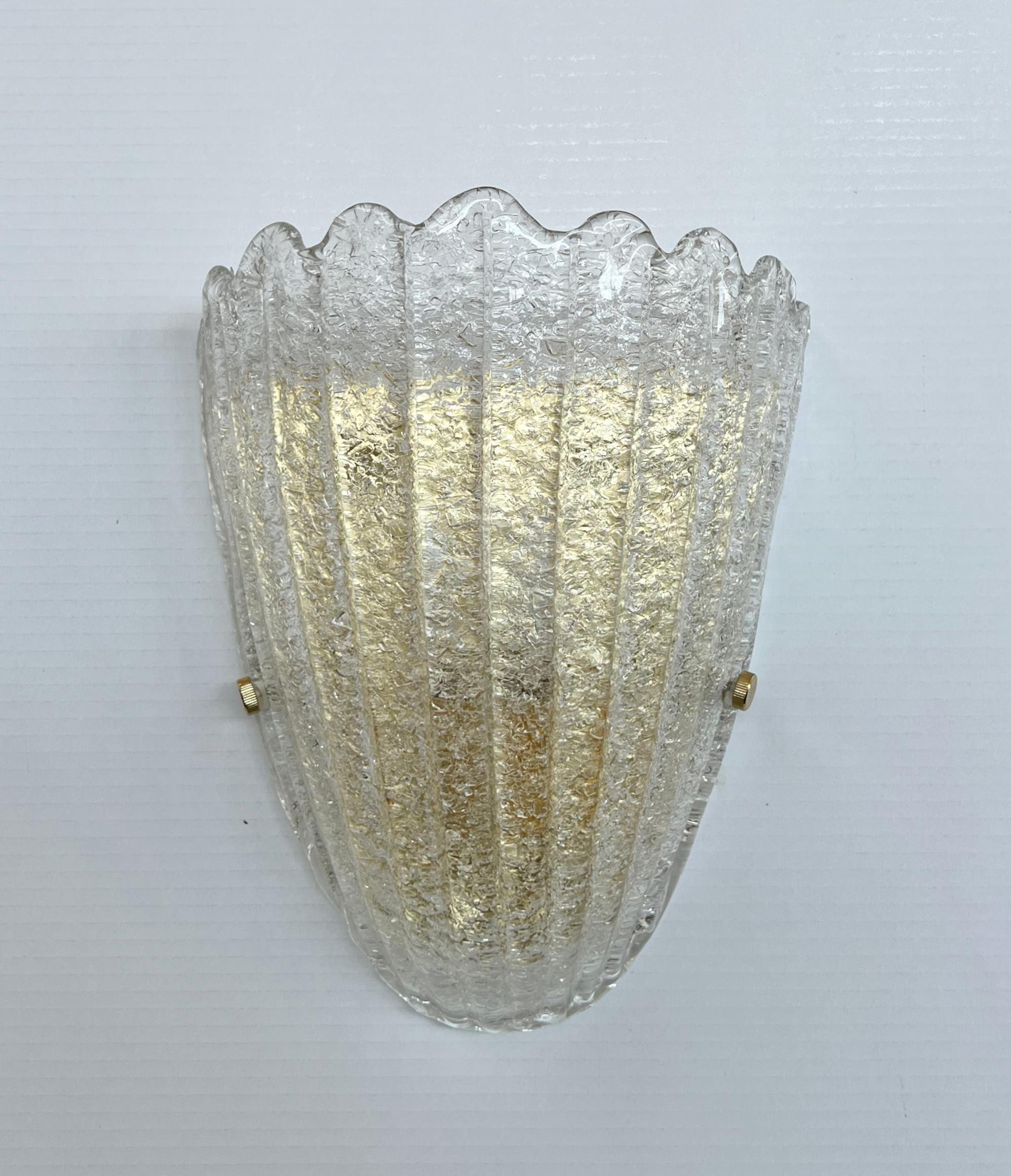 Italian wall light with a Murano glass shield hand blown in Graniglia technique to produce granular textured effect, mounted on gold plated finish frame / Made in Italy
Measures: Height 12 inches, width 9 inches, depth 4 inches
1 light / E26 or E27