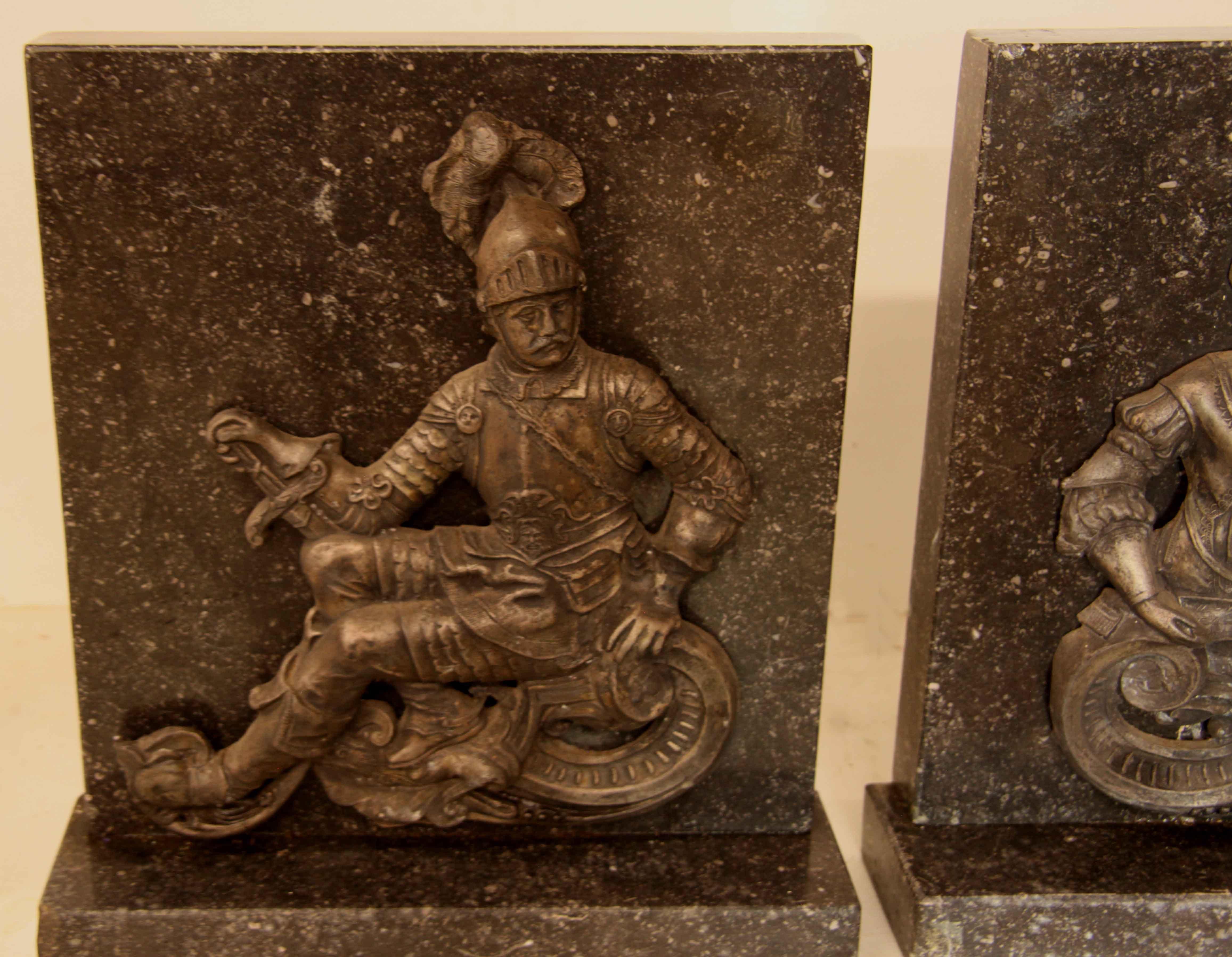 Pair of granite and spelter figurative book ends, one of a French soldier with sword, the other a lady posing with string instrument.  This pair could also serve as decorative objects in the home (on a mantle would be ideal.)  Each one weighs 40