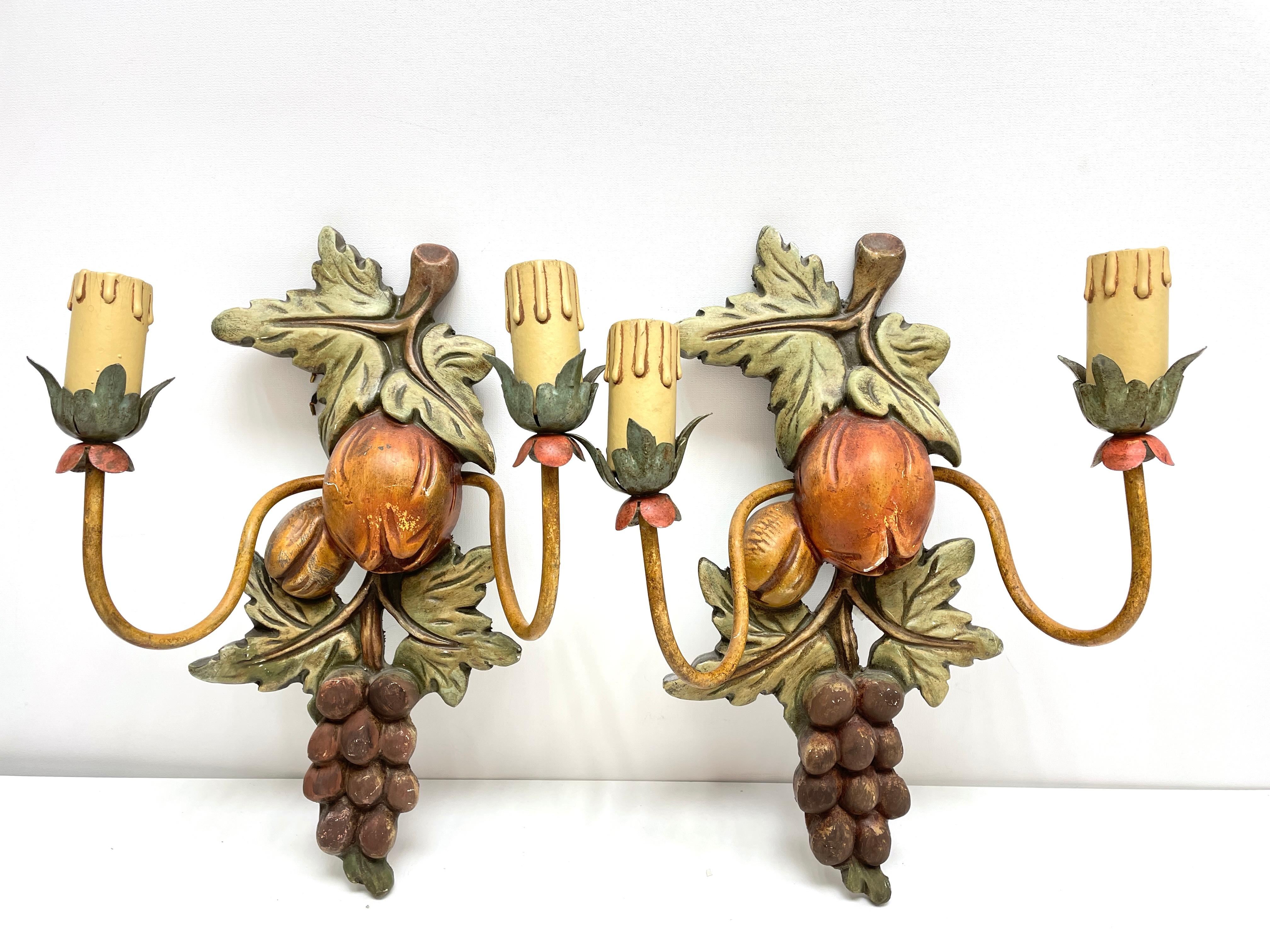 A pair Hollywood Regency midcentury grape, fruits and leaf florentine sconces, each fixture requires two European E14 candelabra bulbs, each up to 40 watts. The wall lights have a beautiful patina and give each room a eclectic statement.