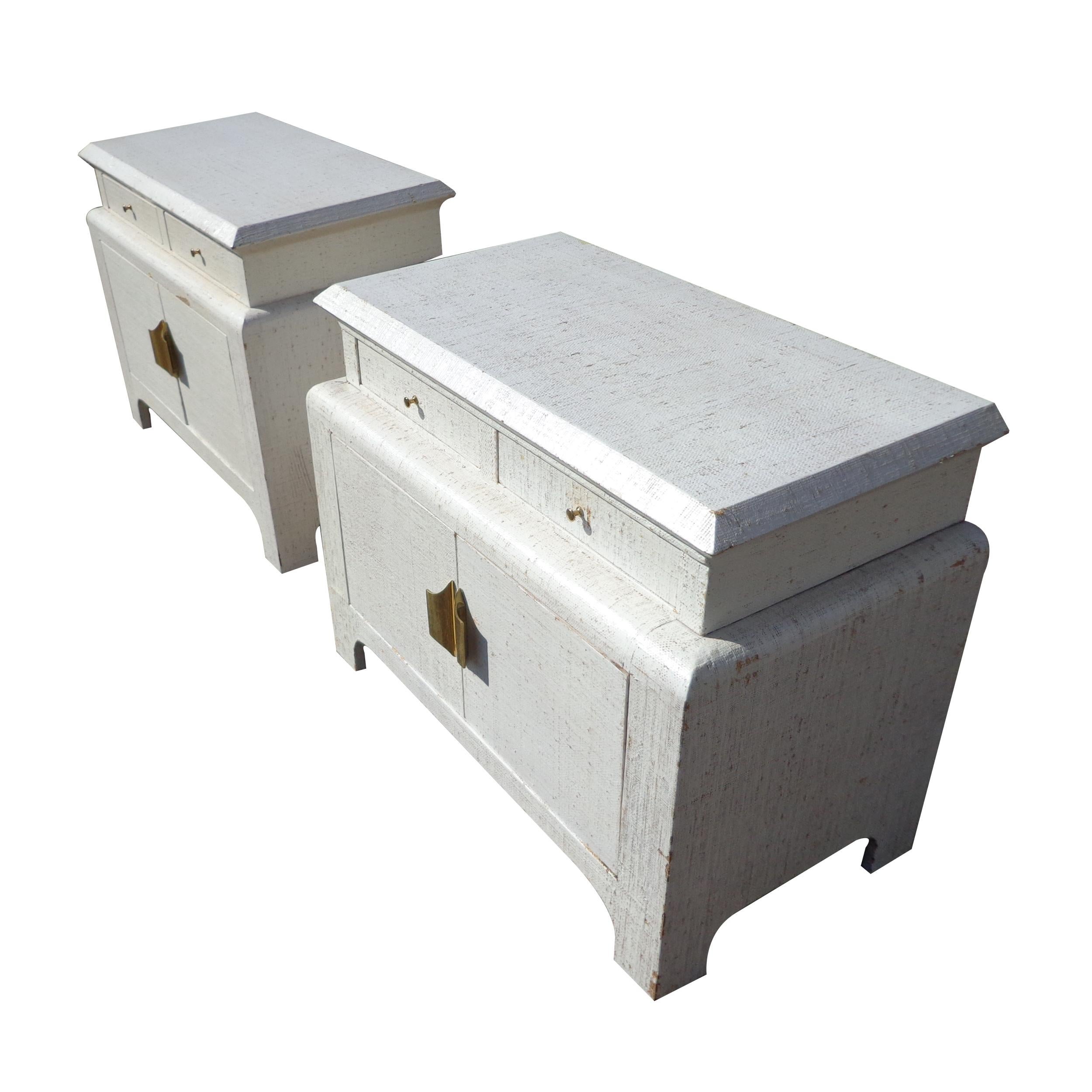 Pair of Grass cloth night stands in the style of Karl Springer
ger 


Stunning Hollywood Regency nightstands restored in white washed grass cloth.
2 drawers with covered shelving below. Original brass pulls.
 