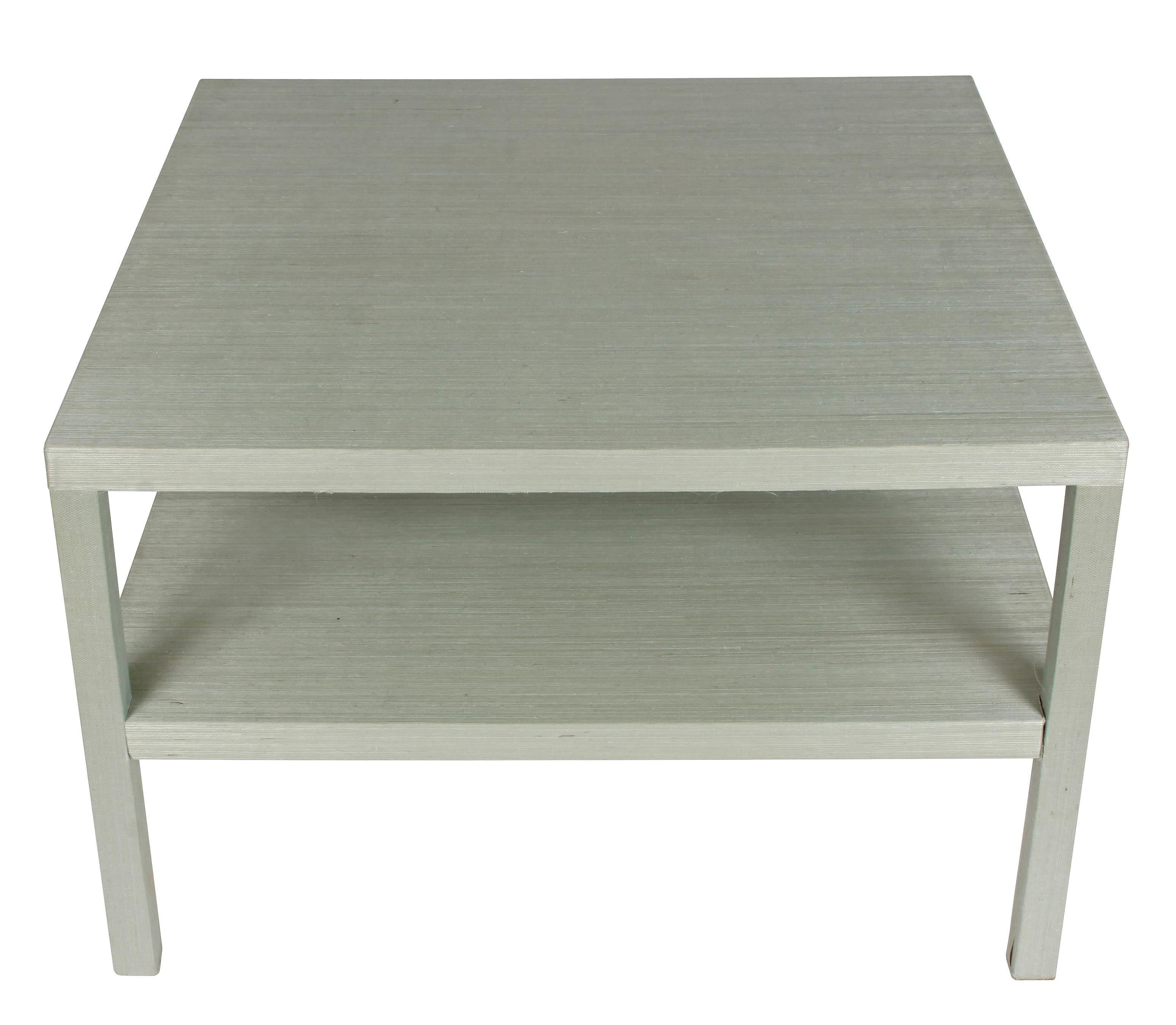 Pair of grasscloth two-tiered tables.