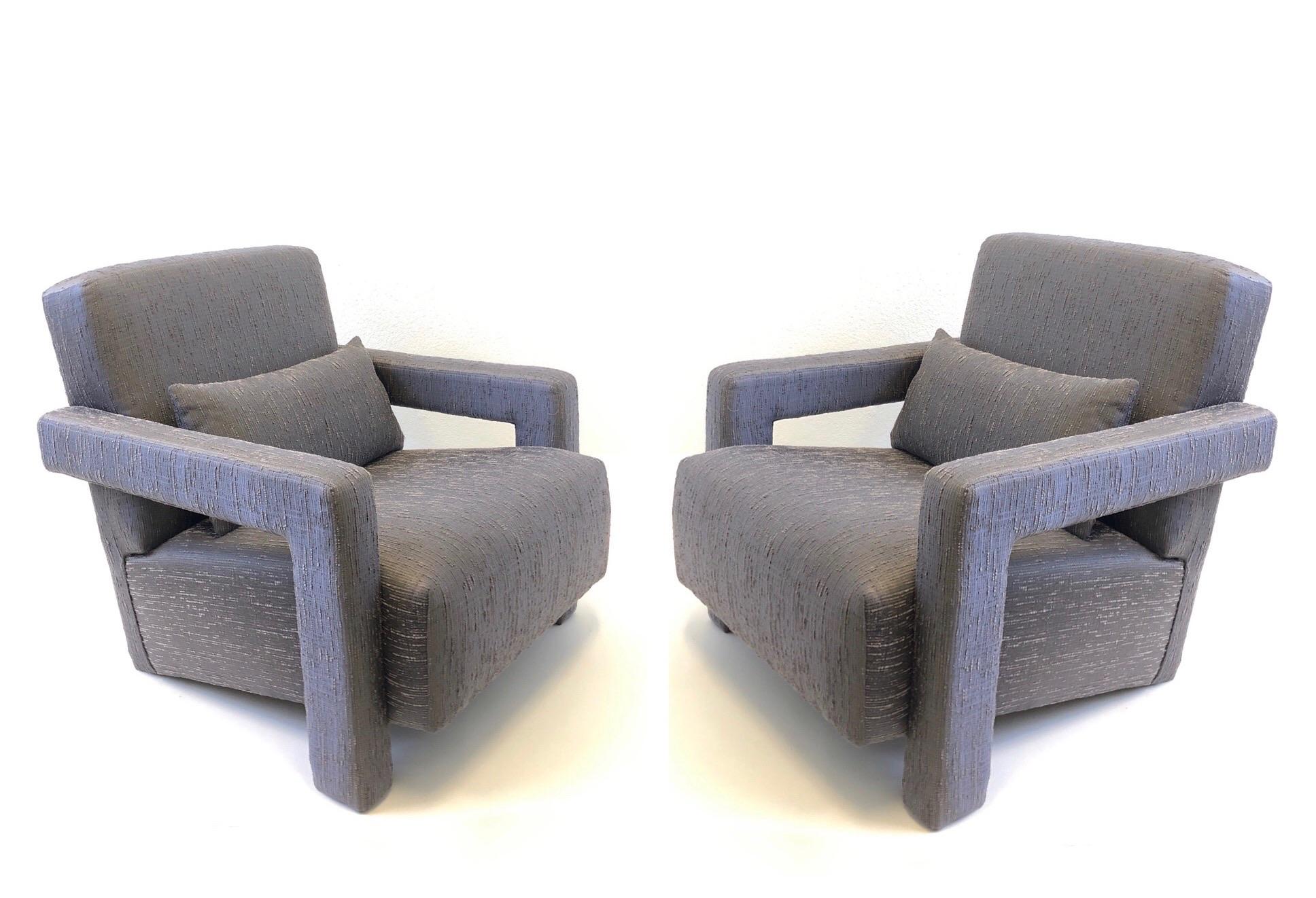 A spectacular pair of Utrecht lounge chairs designed by iconic Dutch Architect Gerrit Thomas Rietveld. The chairs have been recently recovered with a slate gray fabric (see detail photos). 
Measurements: 30” wide 33” deep 30” high 15” seat 20” arm.