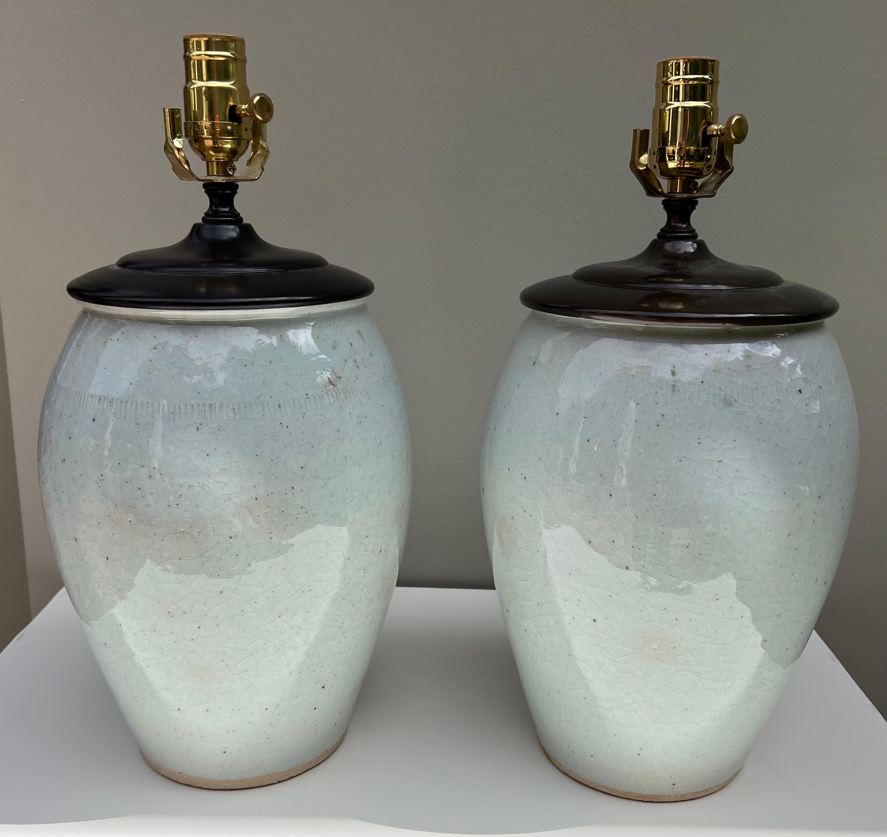 This pair of glazed ceramic lamps is transitional and are easily placed in a multitude of interior settings.
The lamps are newly wired.