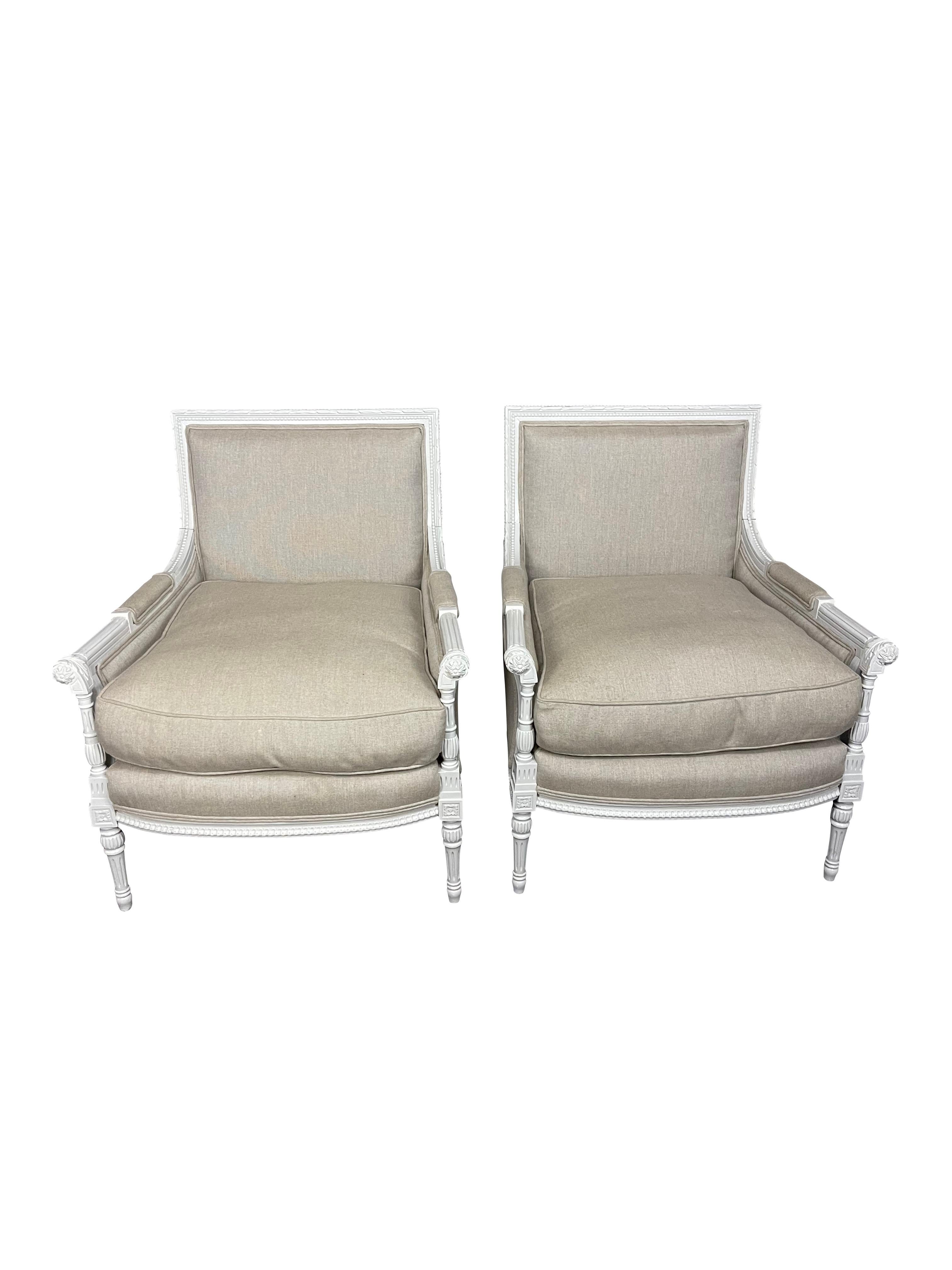 Pair of gray painted Louis XVI Directoire style Bergeres, 20thc., with squared upholstered backs and reeded and bead carved painted frames, with upholstered arms over upholstered cushion seats, on turned tapering legs. Upholstered in taupe woven