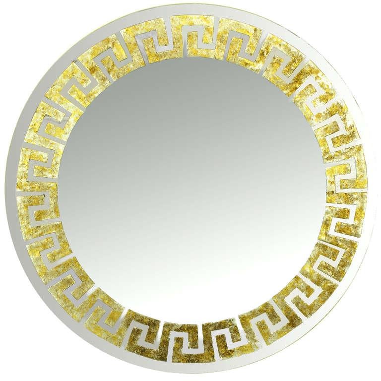 Pair of round, David Marshall signed mirrors with reverse gilt Greek key detail. Each segment of the Greek key design is reverse gilt with gold, silver and copper leaf. Mounted on a round wood backing.

 