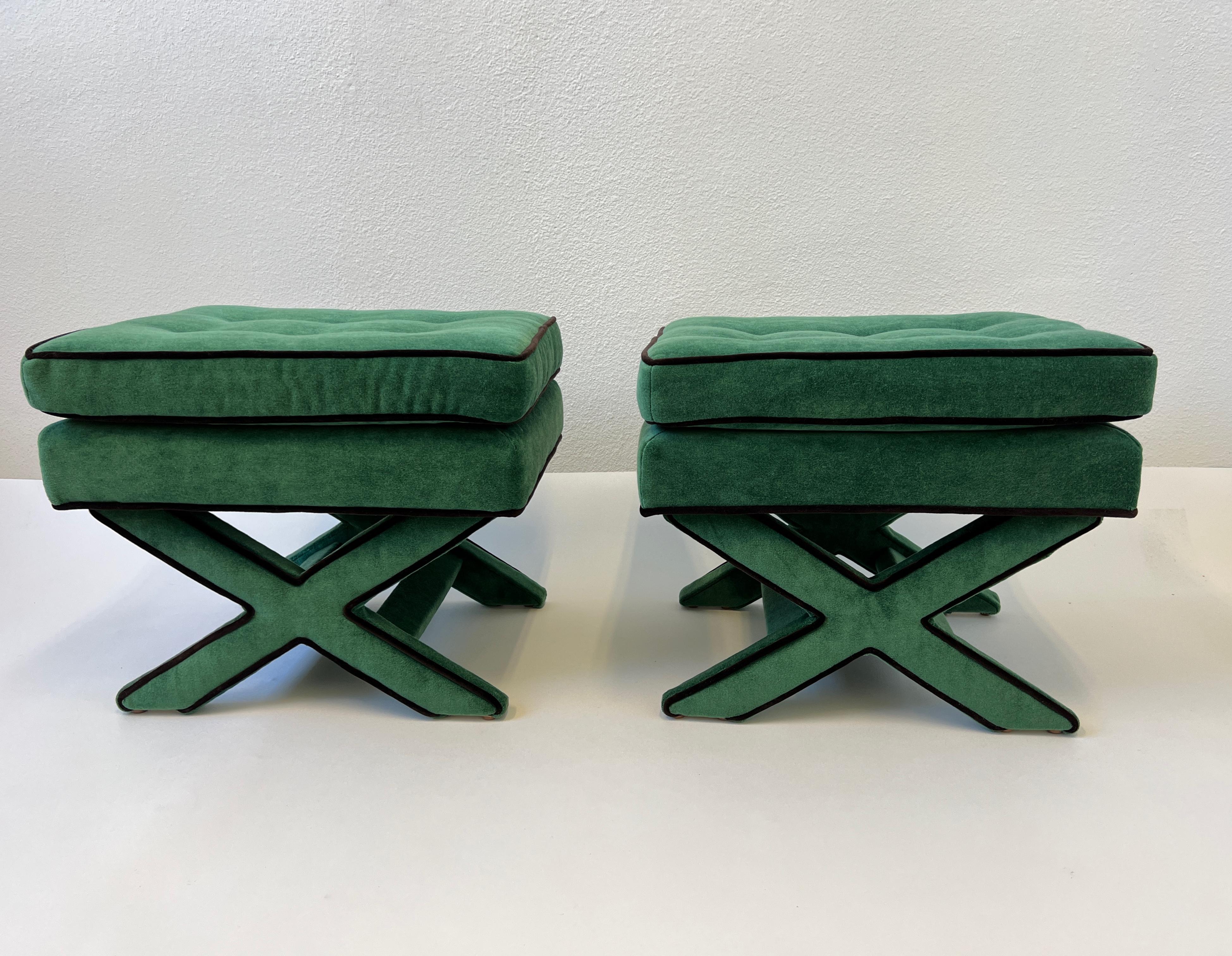 A glamorous pair of green mohair with dark brown velvet piping X base ottomans by Billy Baldwin. 
Newly upholstered. 

Measurements: 22” wide, 18” Deep, 18.5” High. 