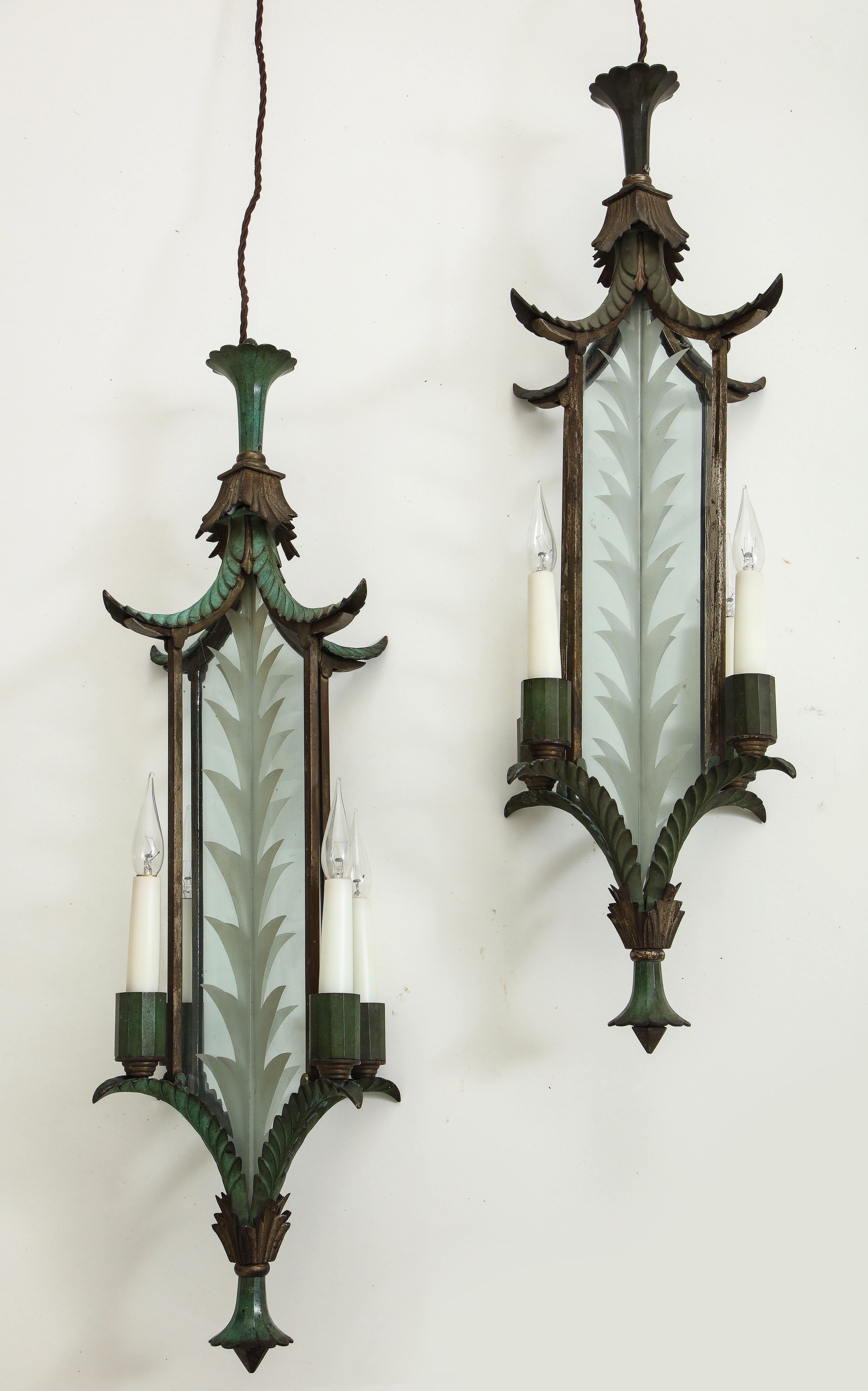 The intersecting glass panes frosted with leaves, surmounted by a foliate canopy; with four electrified candlearms.
