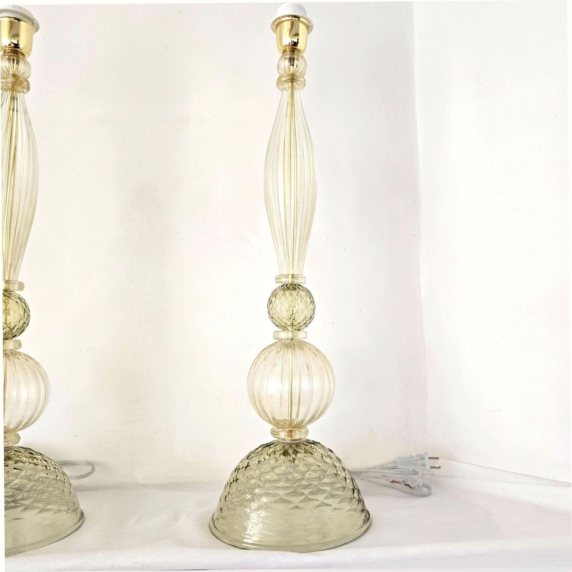 Coppia di lampade di Murano verdi e dorate della metà del secolo scorso, stile Barovier, Italia  1980s.
Le lampade da tavolo o da scrivania hanno uno stile neoclassico.
Sono realizzati a mano in vetro di Murano, con colori delicati: un verde oliva