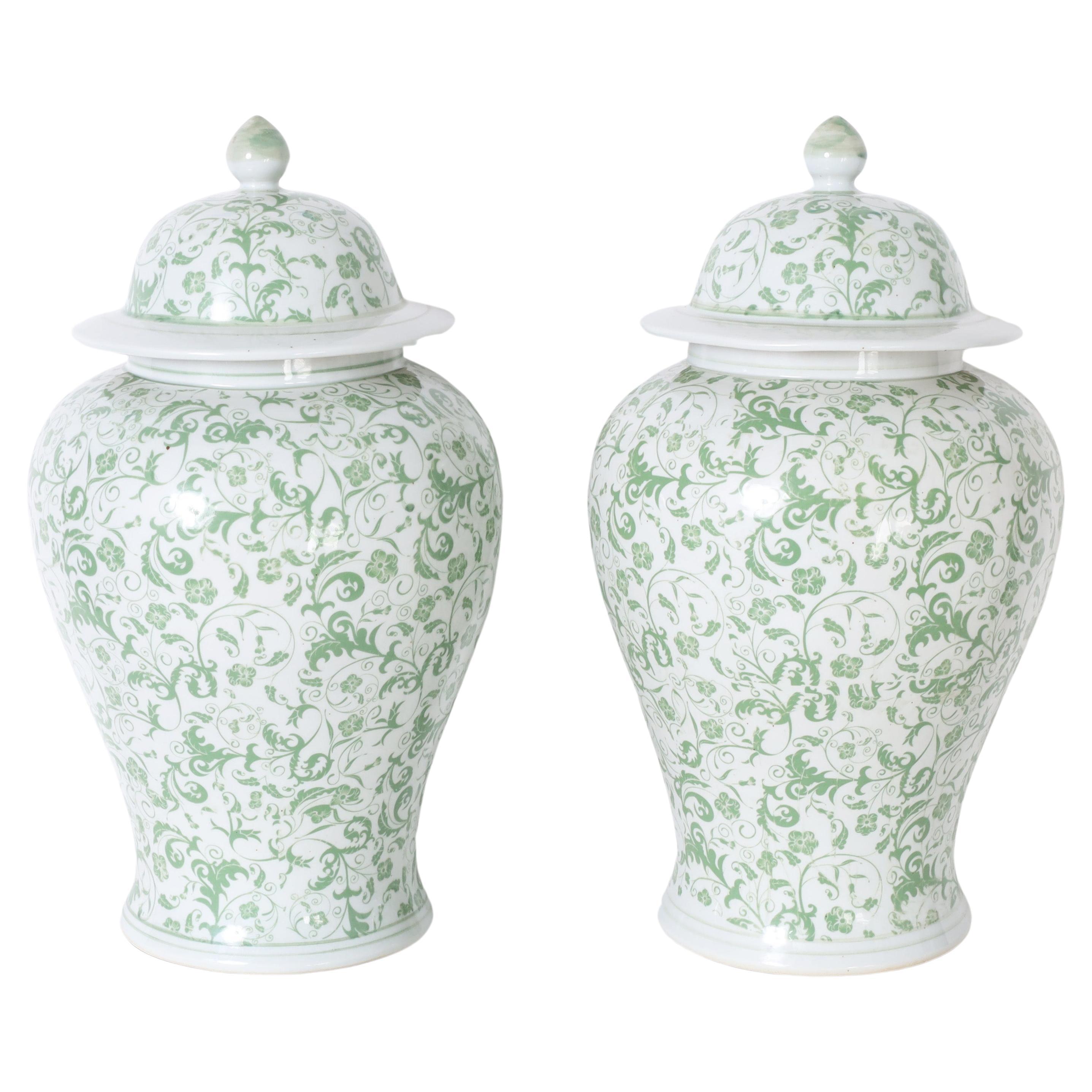 Pair of Green and White Lidded Urns or Jars