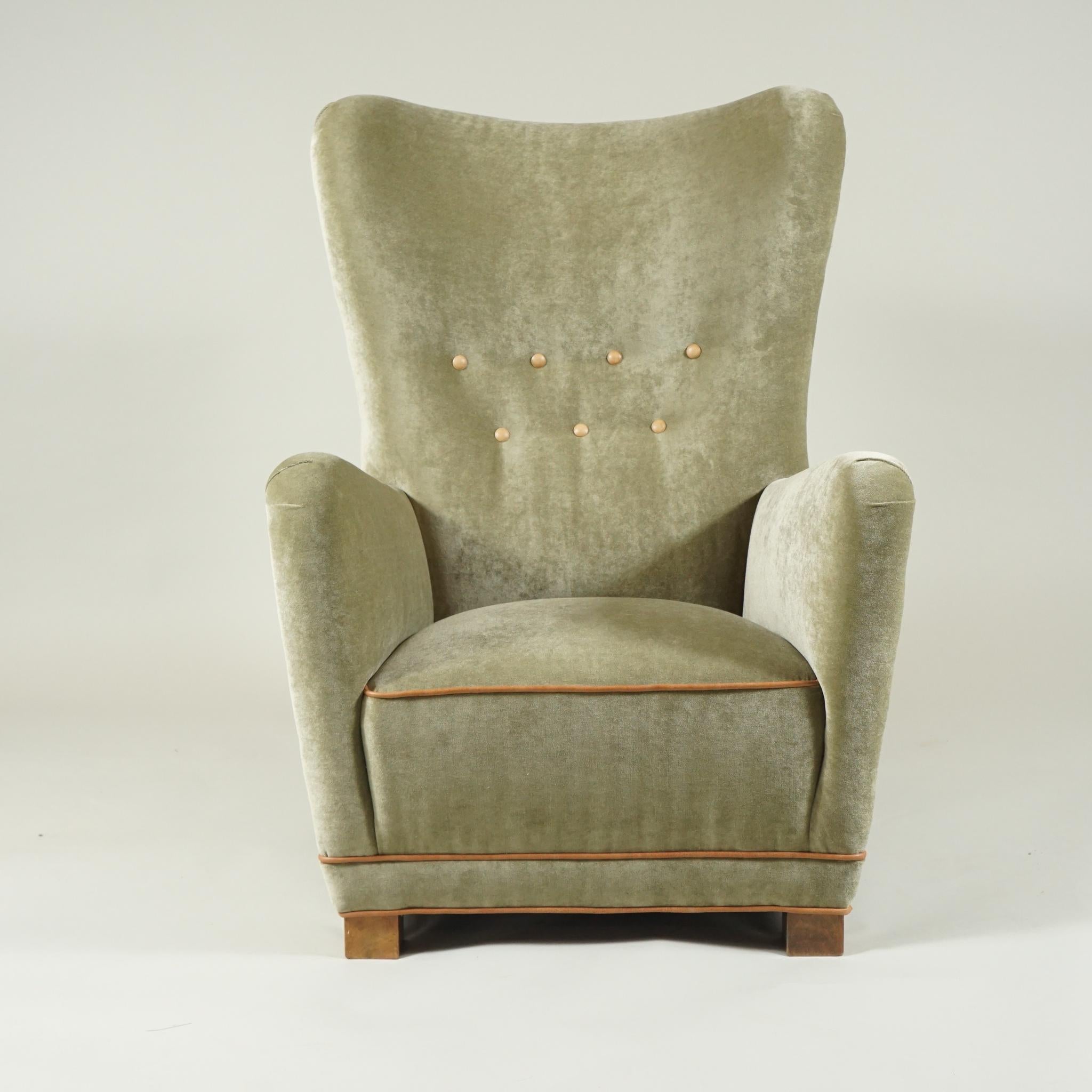 A pair of high-backed Fritz Hansen armchairs of great form newly recovered in a soft green mohair fabric,
from 1930s, Denmark.