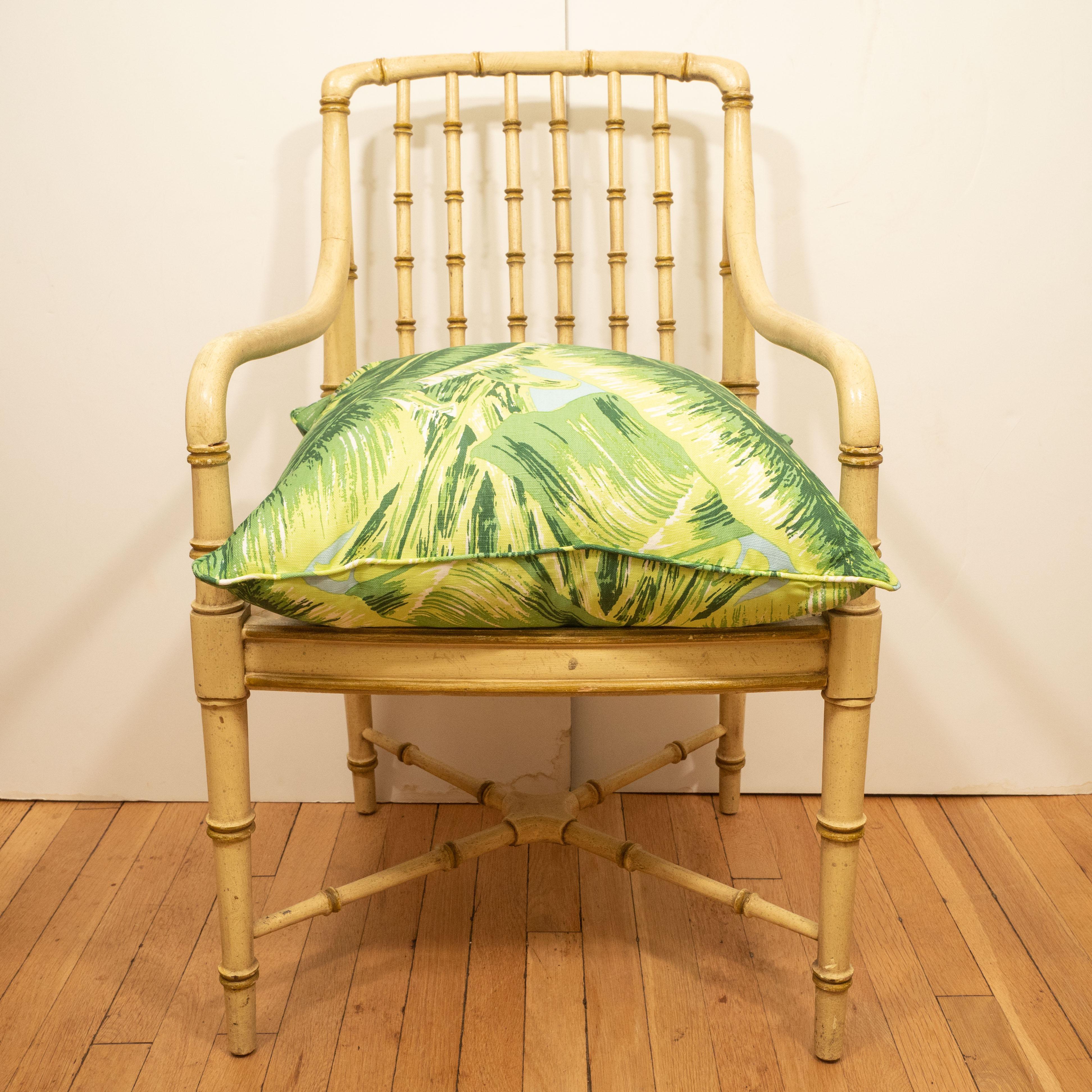A stylish pair of vintage faux bamboo arms chairs by Bernhardt painted in a green/yellow with nice detailing on sides, back and cross stretcher. We have displayed them in our shop with a colorful cushion (not included but available for purchase).