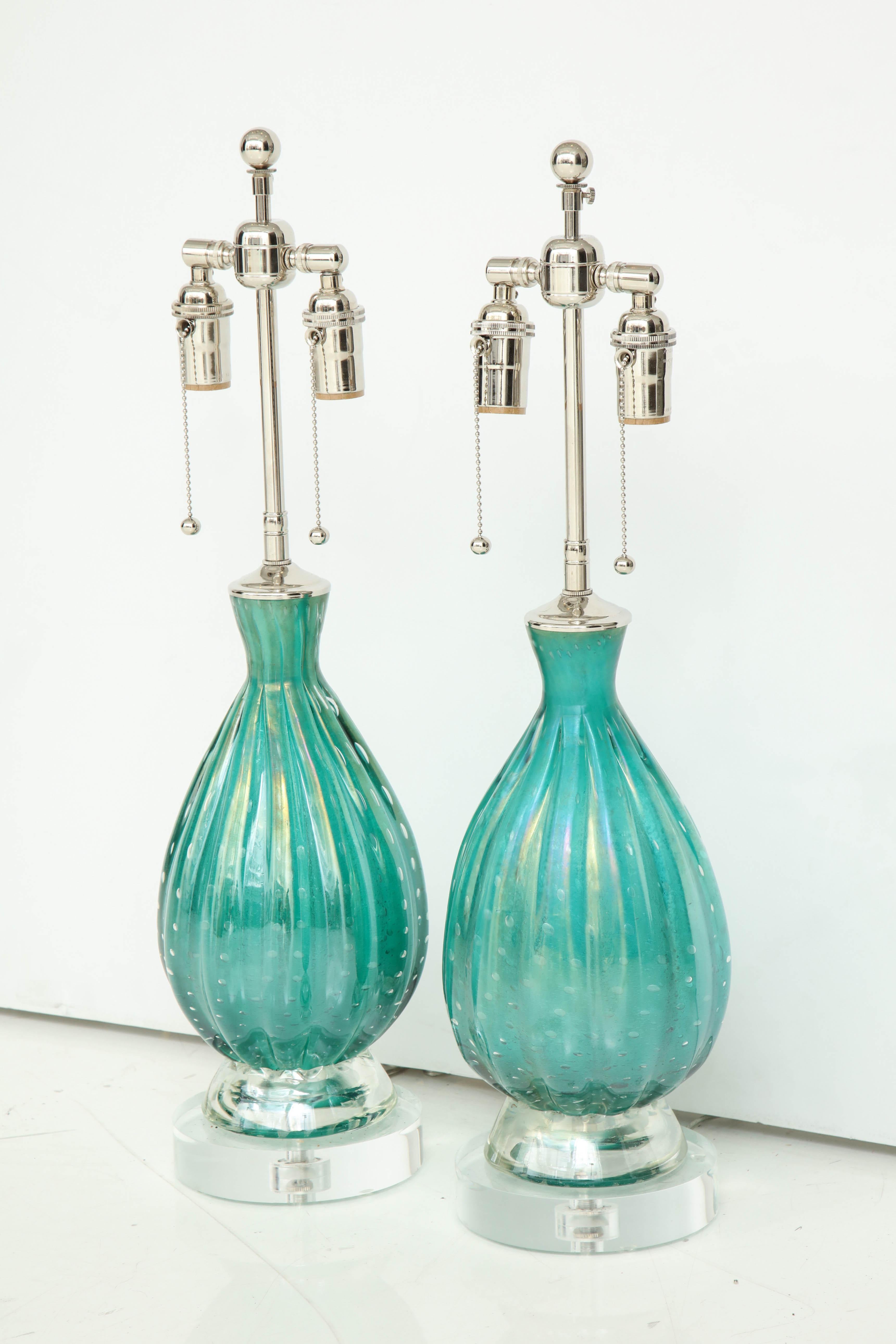 Pair of Barovier lamps with controlled bubbles in an exquisite green.
The lamps are mounted on thick Lucite bases and they have been newly rewired for the US with polished nickel double clusters that take standard light bulbs.
The overall height of