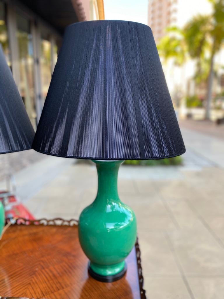 Wonderful color from the 70's having a double light in each brass metal and black wooden base. The string shades are new and also black.