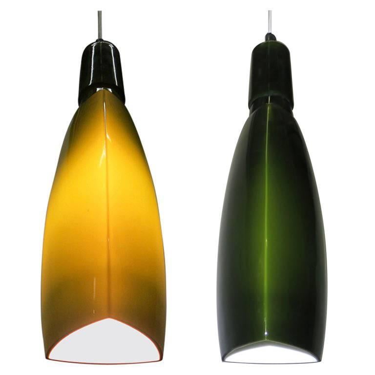 Pair of vintage, Italian green cased glass ceiling lights by Stilnovo each with a single socket and a bowed, triangular shaped opening/base. Measurements provided encompass the glass pendant. The overall drop can be adjusted from the wire.