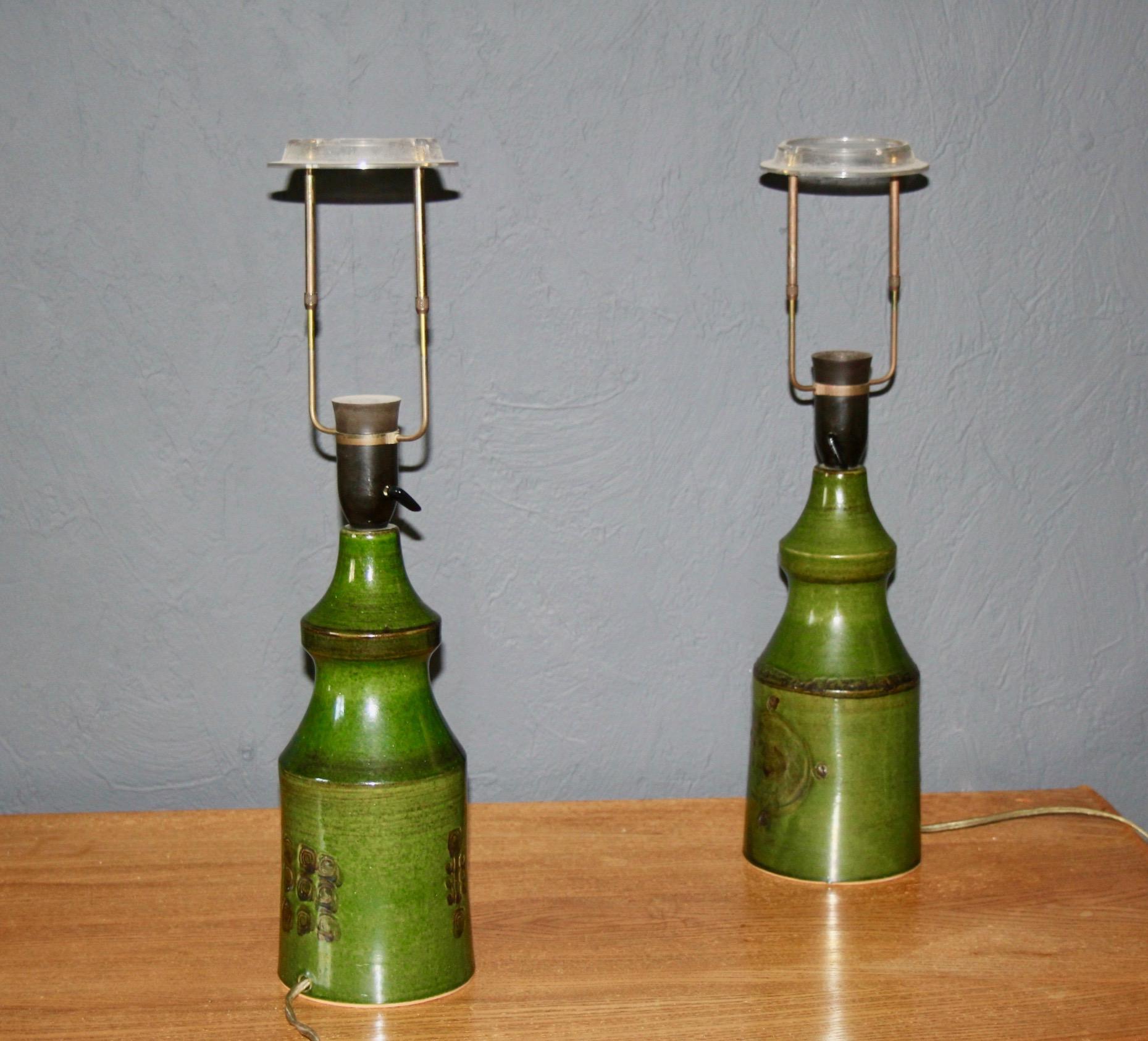 Pair of green ceramic engraved at the bottom danish table lamps.
Some small stains on the shades but can be turned in a way that you don't see them from the front.