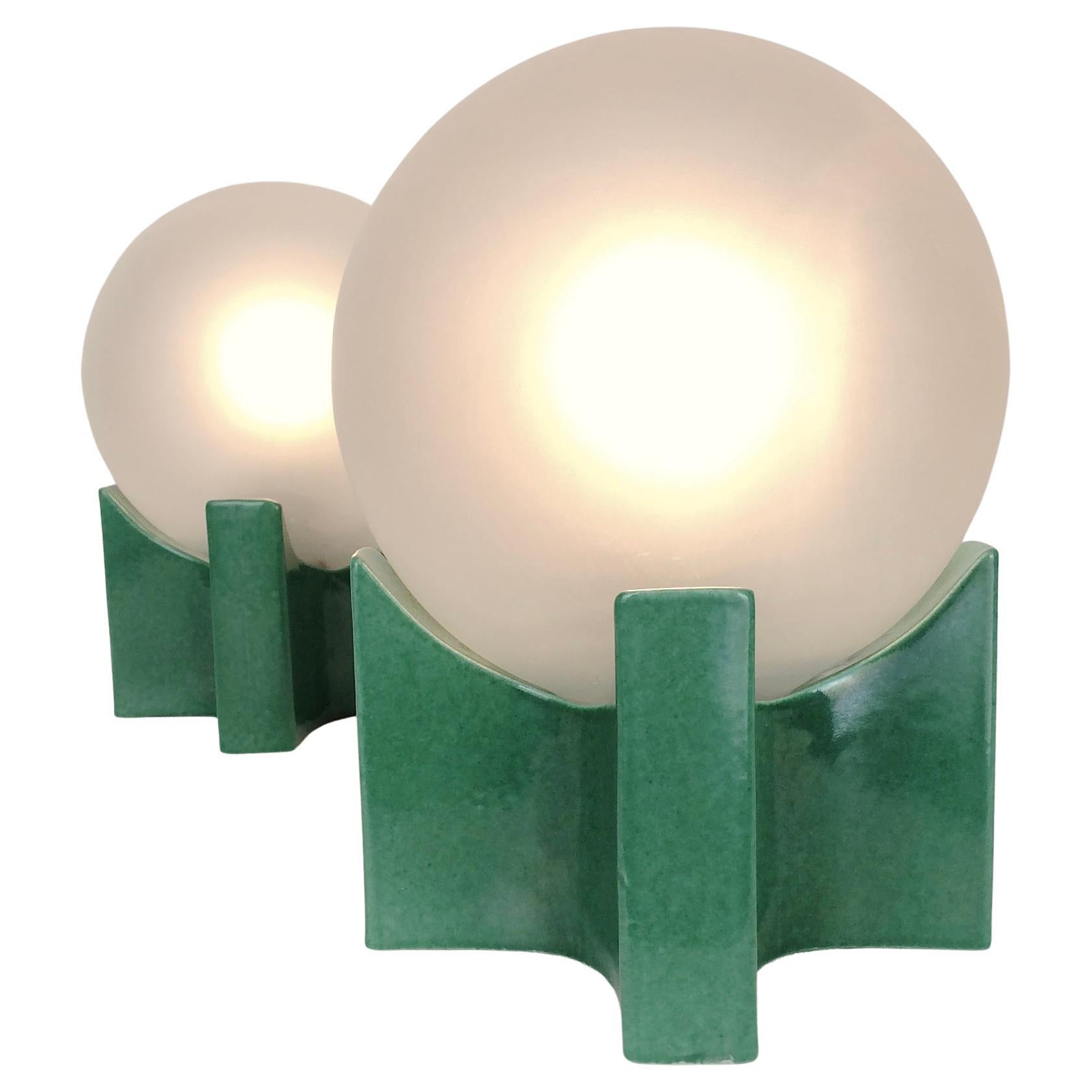 Nice pair of table lamps, circa 1960, Italy.
Green ceramic and frosted glass globe.
Dimensions: 18 cm H, 13 cm W, 13 cm D.
All purchases are covered by our Buyer Protection Guarantee.
This item can be returned within 7 days of delivery.


 