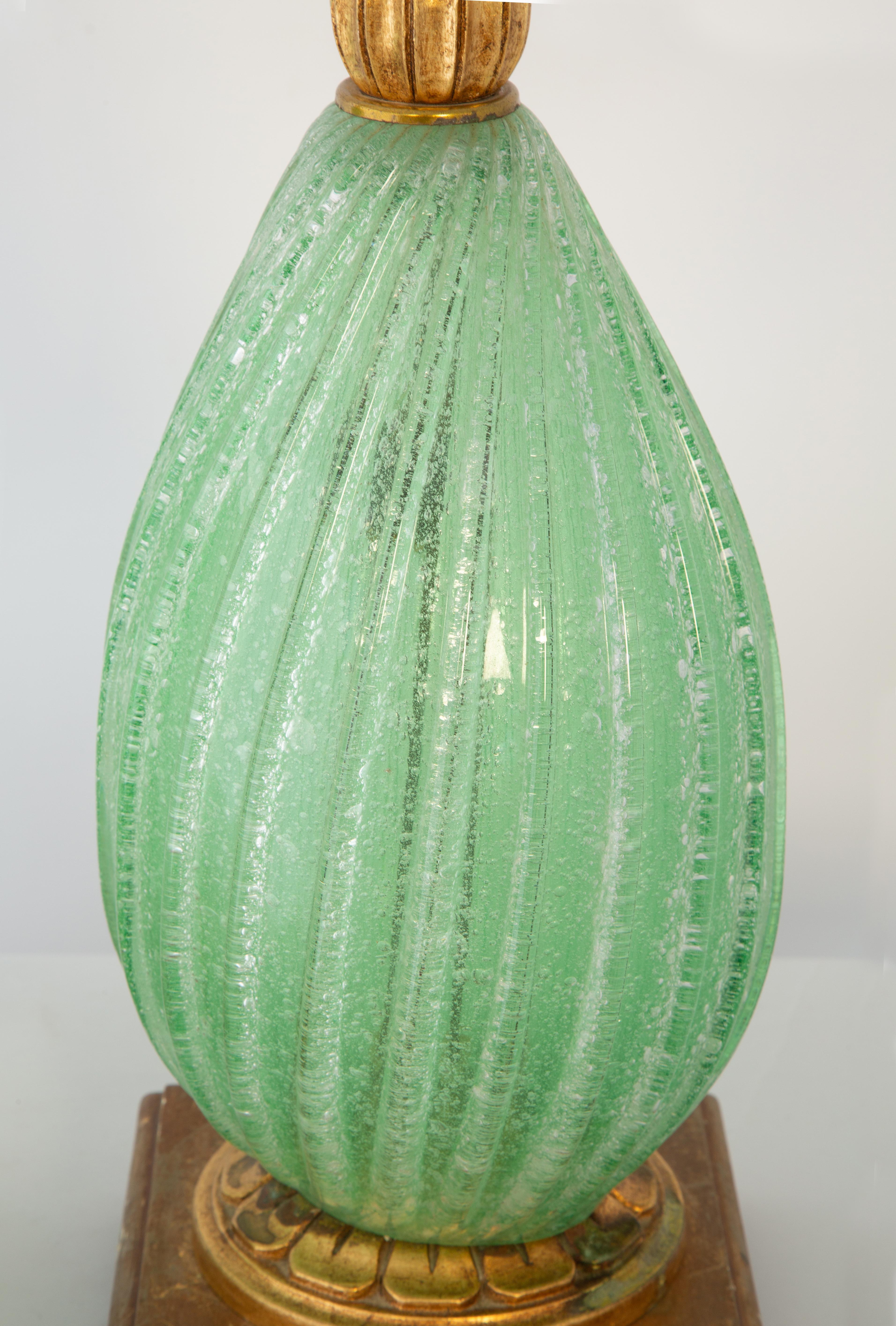 Pair of Murano lamps in green, handblown in a spiral lobular form, with carved giltwood neck, mounted on a square plinth on ball feet.

Stock ID: D4226