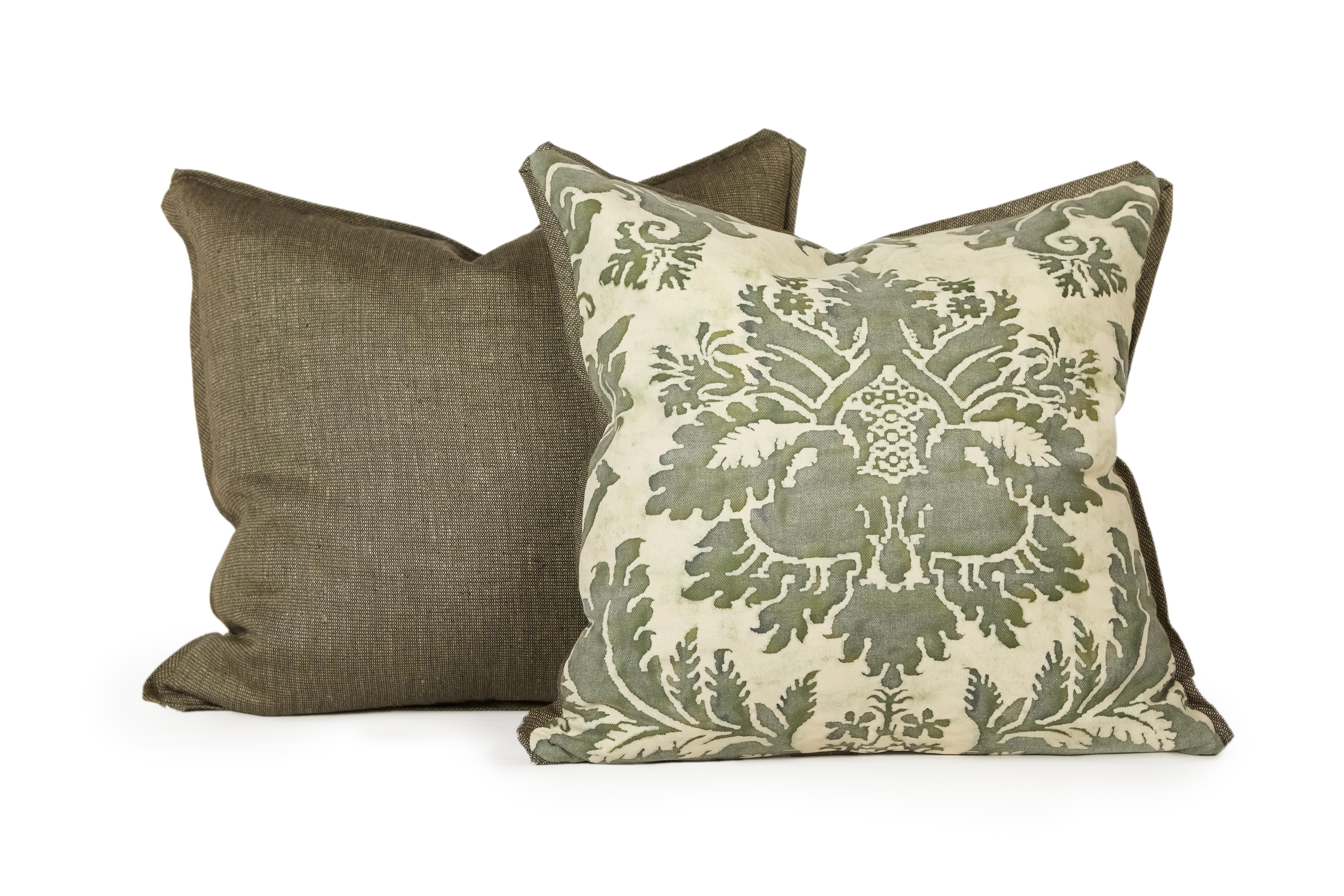A beautiful pair of Fortuny fabric cushions in the Glicine pattern, with a pale green and olive green colorway. Cushions feature bias edging and matching dark green backing. The pattern is a 17th century Italian design with wisteria motif.

Newly