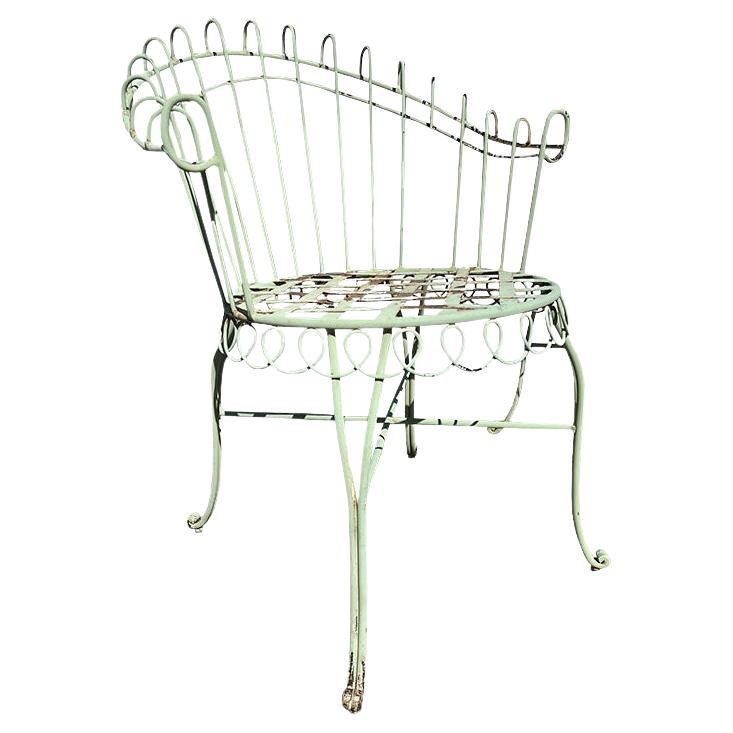 Elevate your outdoor or indoor space with this rare pair of vintage French wrought iron garden chairs, exuding timeless elegance and Parisian charm. Crafted in the late 19th or early 20th century, these chairs boast an intricate scrollwork design,