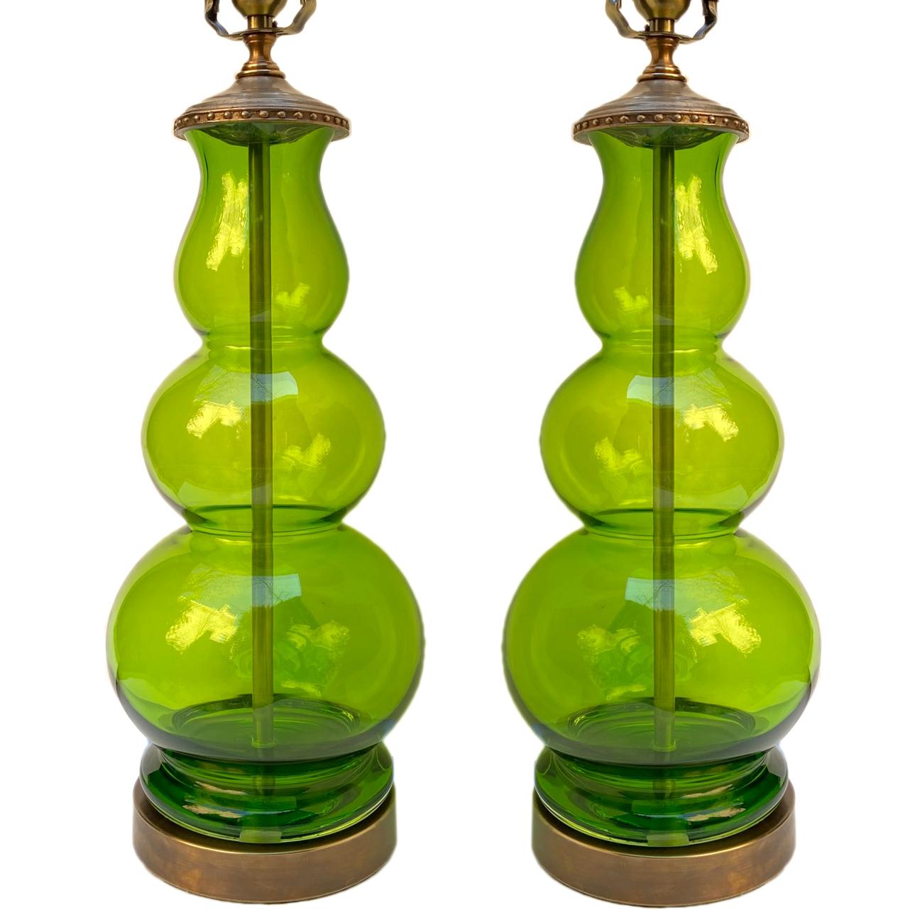 A pair of circa 1950s Italian green blown glass porcelain lamps.

Measurements:
Height of body 18”
Diameter at widest 6”.