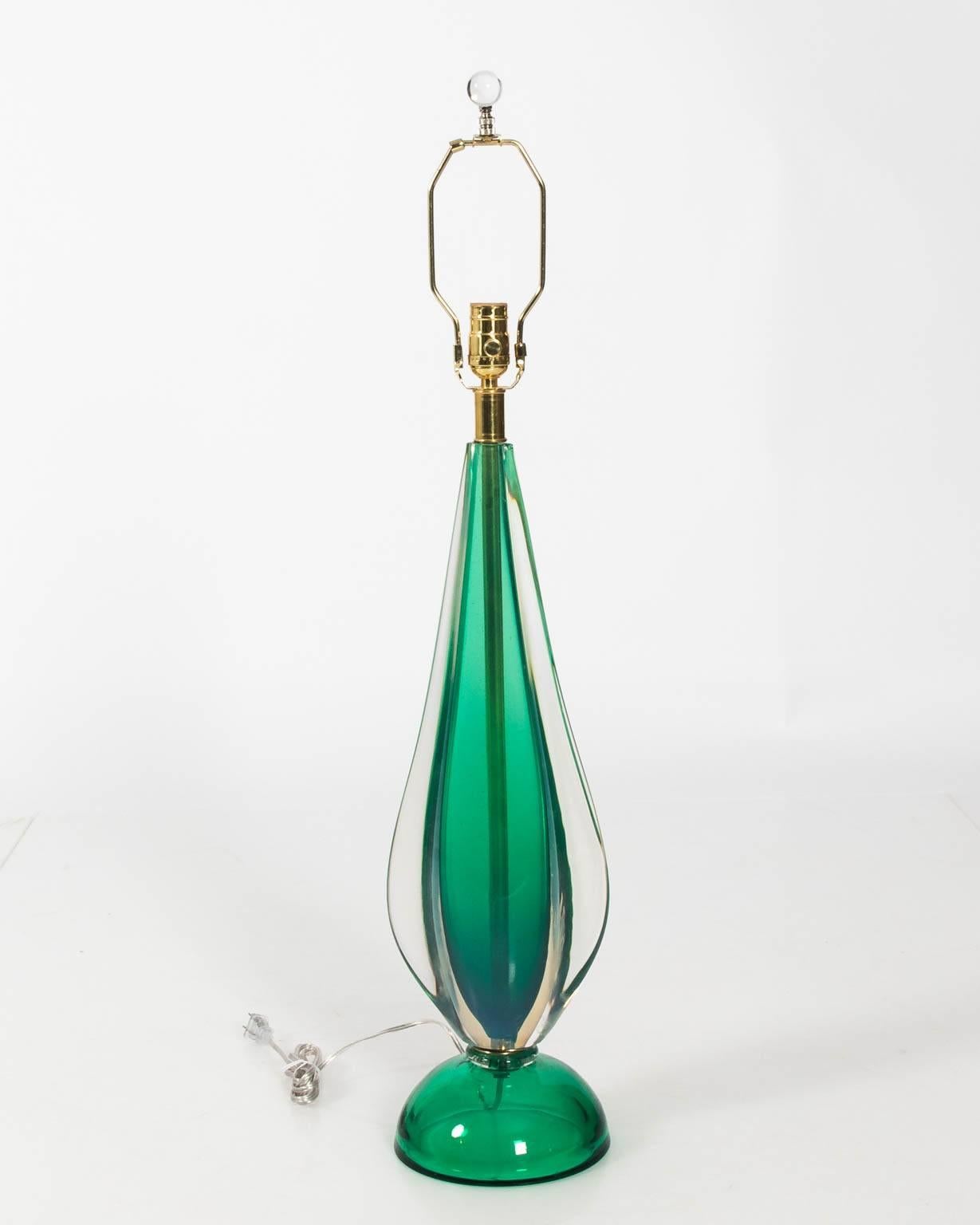 Pair of Mid-Century Modern style heavy green colored Murano glass lamps, with brass fittings, circa 1970s.