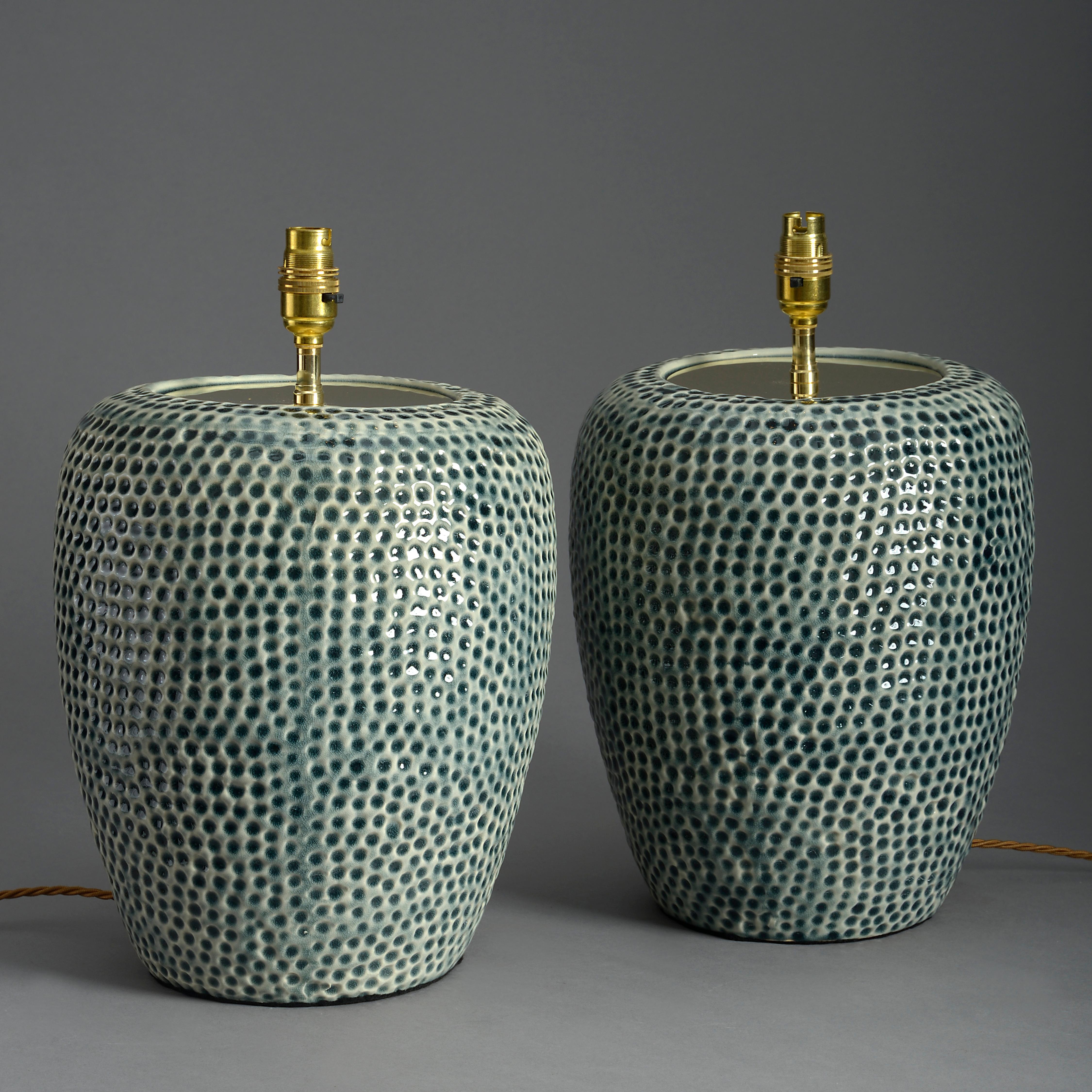 A pair of ceramic lamps, the dimpled jars with turquoise green glazed surfaces. 

Shades not included.
