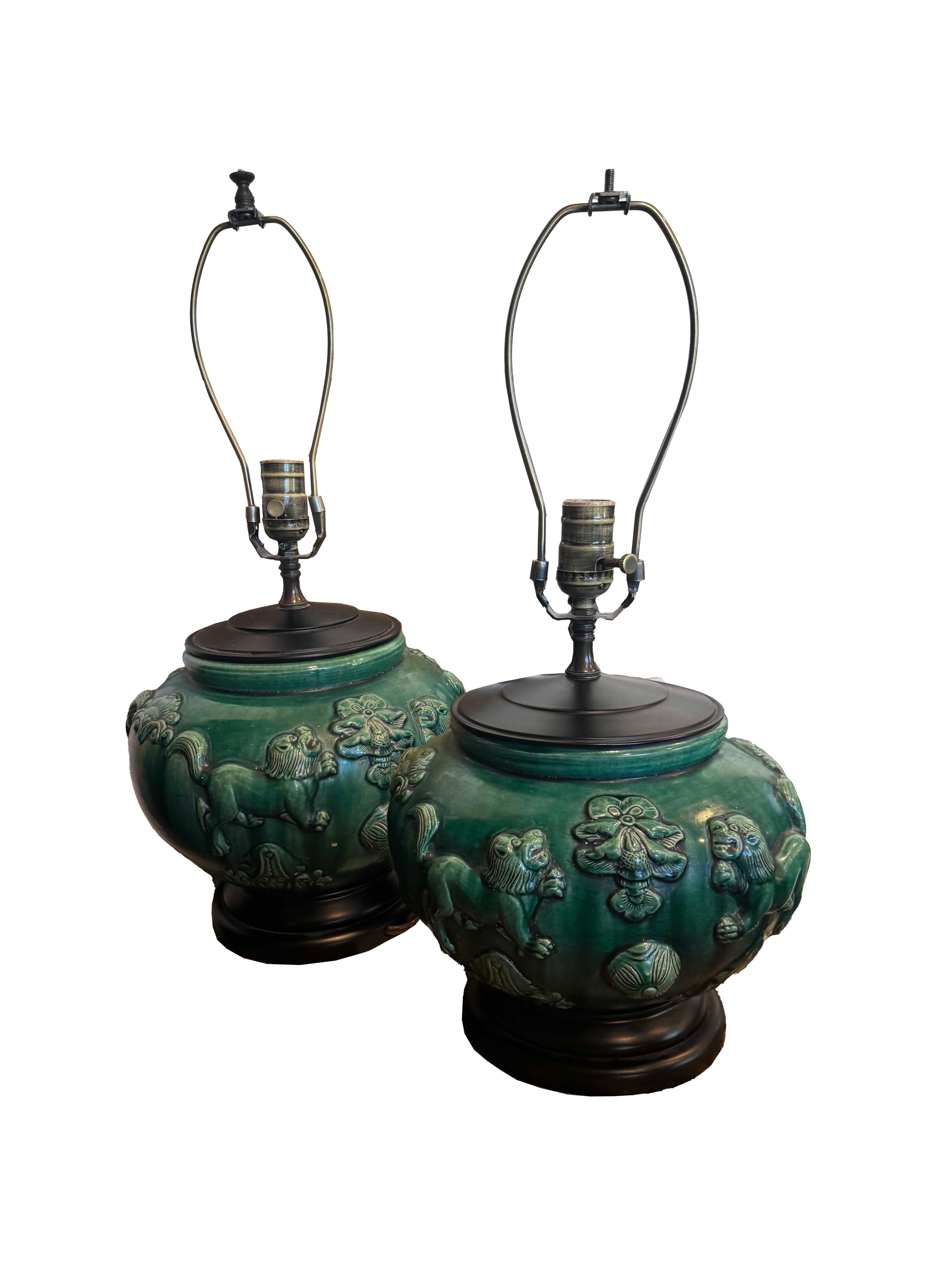 Add a touch of elegance and exotic flair to your living space with this stunning pair of Green Chinese glazed ceramic vase lamps. Crafted with meticulous attention to detail, each lamp boasts intricate reliefs of majestic lions and delicate floral