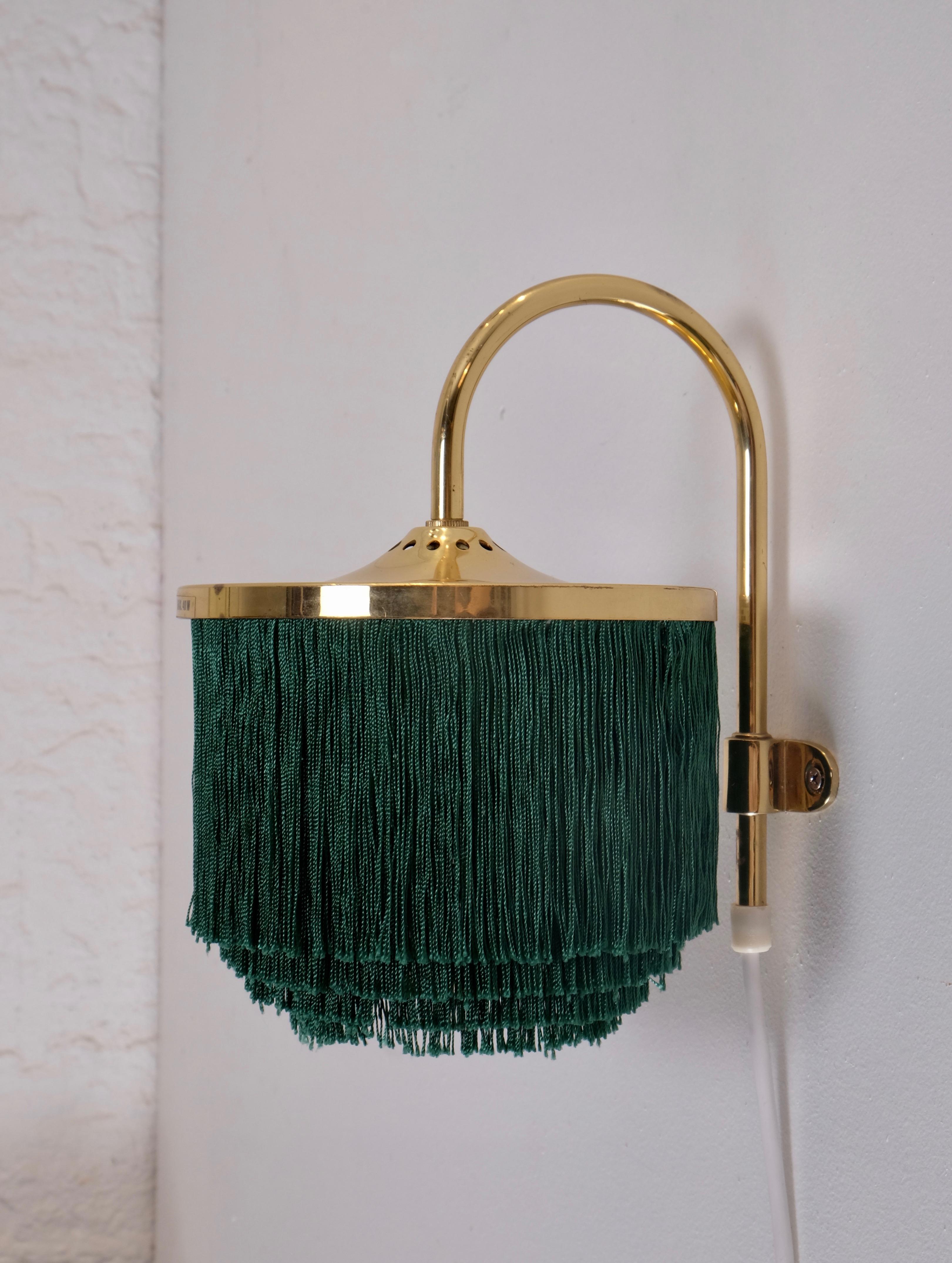 Swedish fringes wall light model V271 designed by Hans-Agne Jakobsson, produced in Markaryd, Sweden, 1960s.
Listed price is for a pair.

Measures: Diameter 16.5 cm
Distance from wall 19.5 cm
Top of arm to bottom of shade 23 cm
Height 16