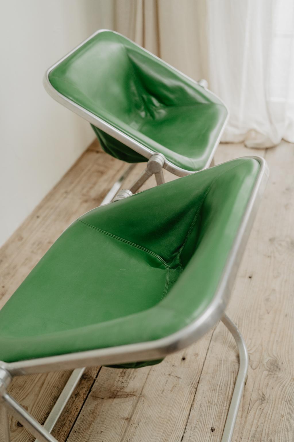 pair of green leather folding Plona chairs 2