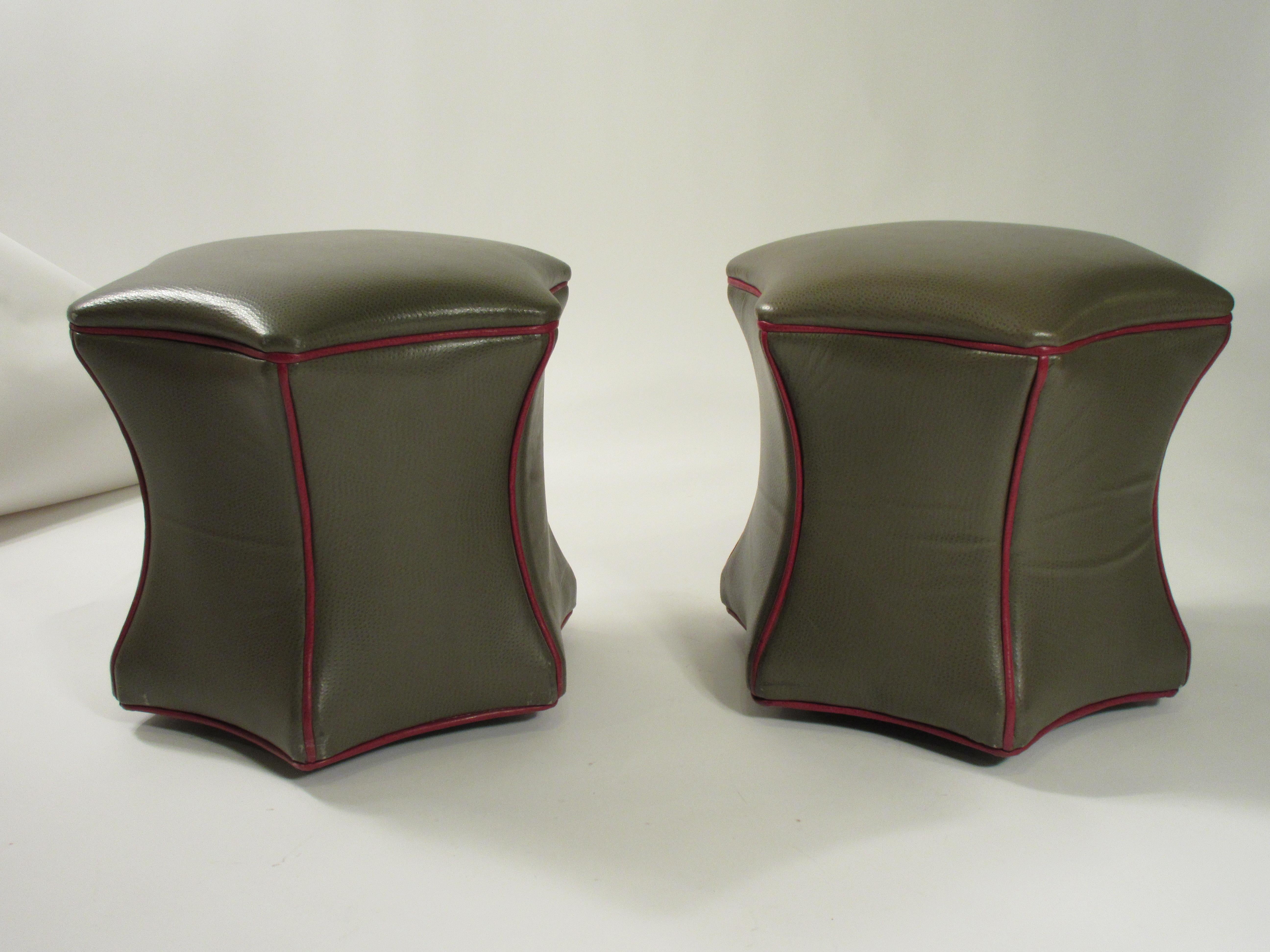 Pair of leather ottomans on wheels.