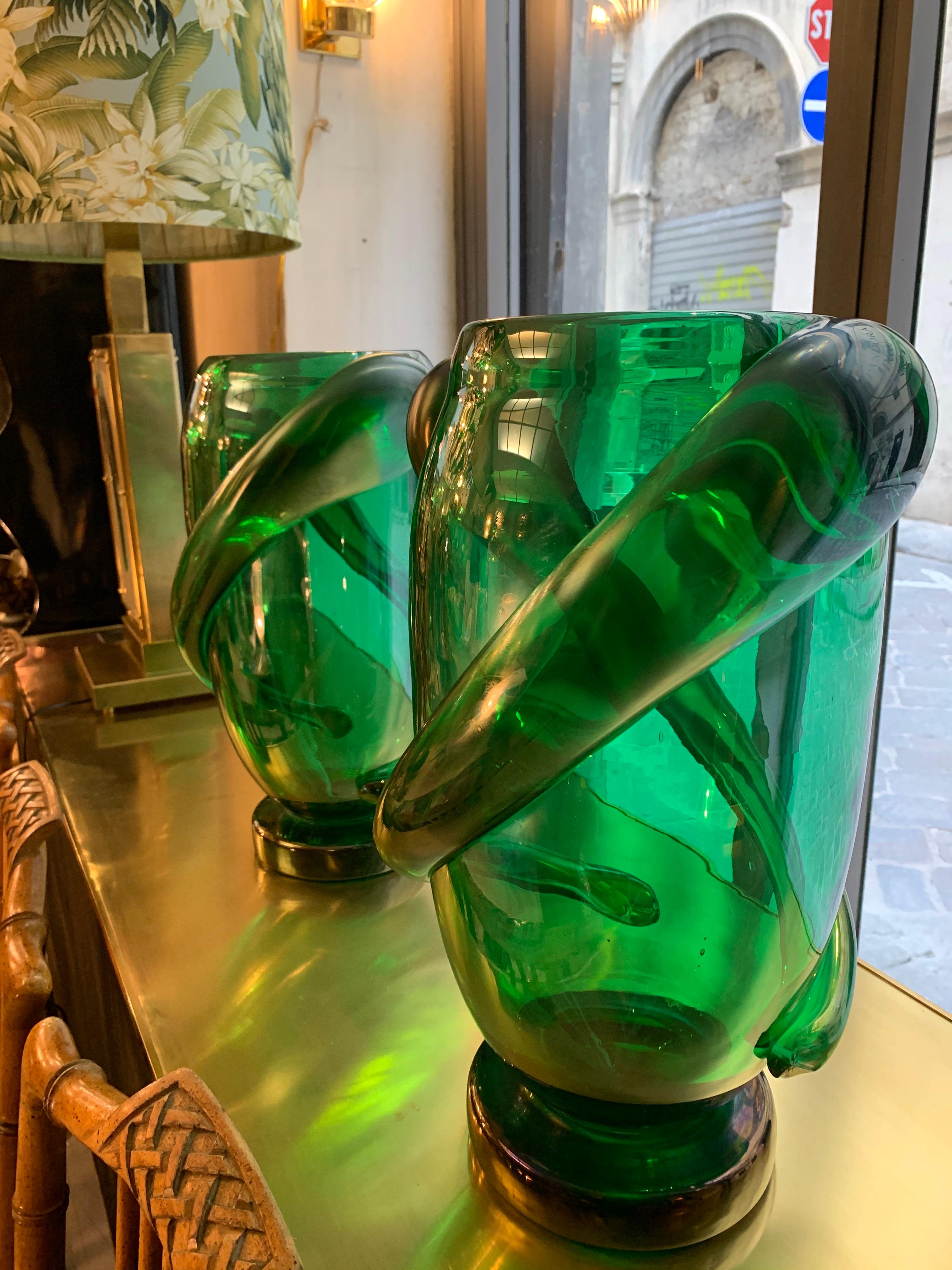 Pair of green Murano glass hand blown vases signed by Costantini.
The body of the vase is decorated with spiral freeform iridescent reliefs.
Can be sold individually.